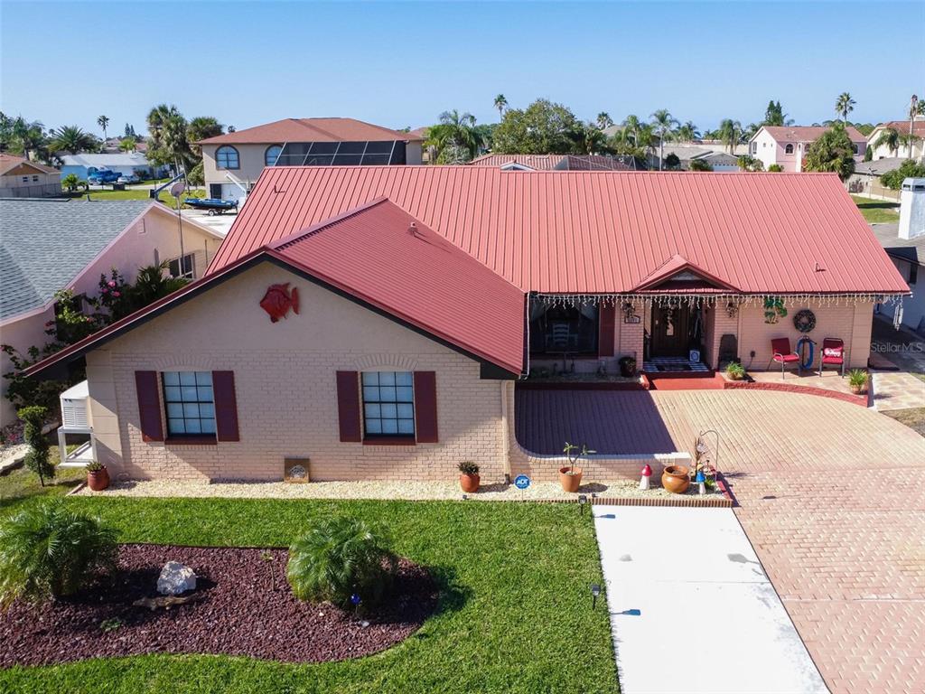 This is your next home with Gulf access! In addition to the side facing 2-car garage, there is plenty of space in your driveway for your vehicles and toys. From your front entry door, you immediately feel relaxed with a view of your pool and the water. No lack of space with 3 bedrooms, 2 full bathrooms (one master ensuite), split bedrooms, inside laundry room, and plenty of closet space, this is the perfect home to entertain and keep your privacy. No need to worry about losing power if inclement weather strikes, you have a 150-amp Generac system installed in 2021 that automatically provides service, so life keeps moving and you stay comfortable. So many features we can't list them all, but here are a few: updated exterior light fixtures and fans, composite deck, water and electric at your dock with cleaning sink, 8000lb elevator remote controlled lift, 2nd lift is manual button controlled, newer pavers in driveway and pool deck, landscaping and front entry door. Inside you will love your low maintenance, continuous plank tile flooring throughout, updated kitchen cabinets as well as appliances, cabinet hardware and granite counters, updated bathrooms, light fixtures and more! Add this to your list of homes to see before you miss out! Remediation completed and insurable.