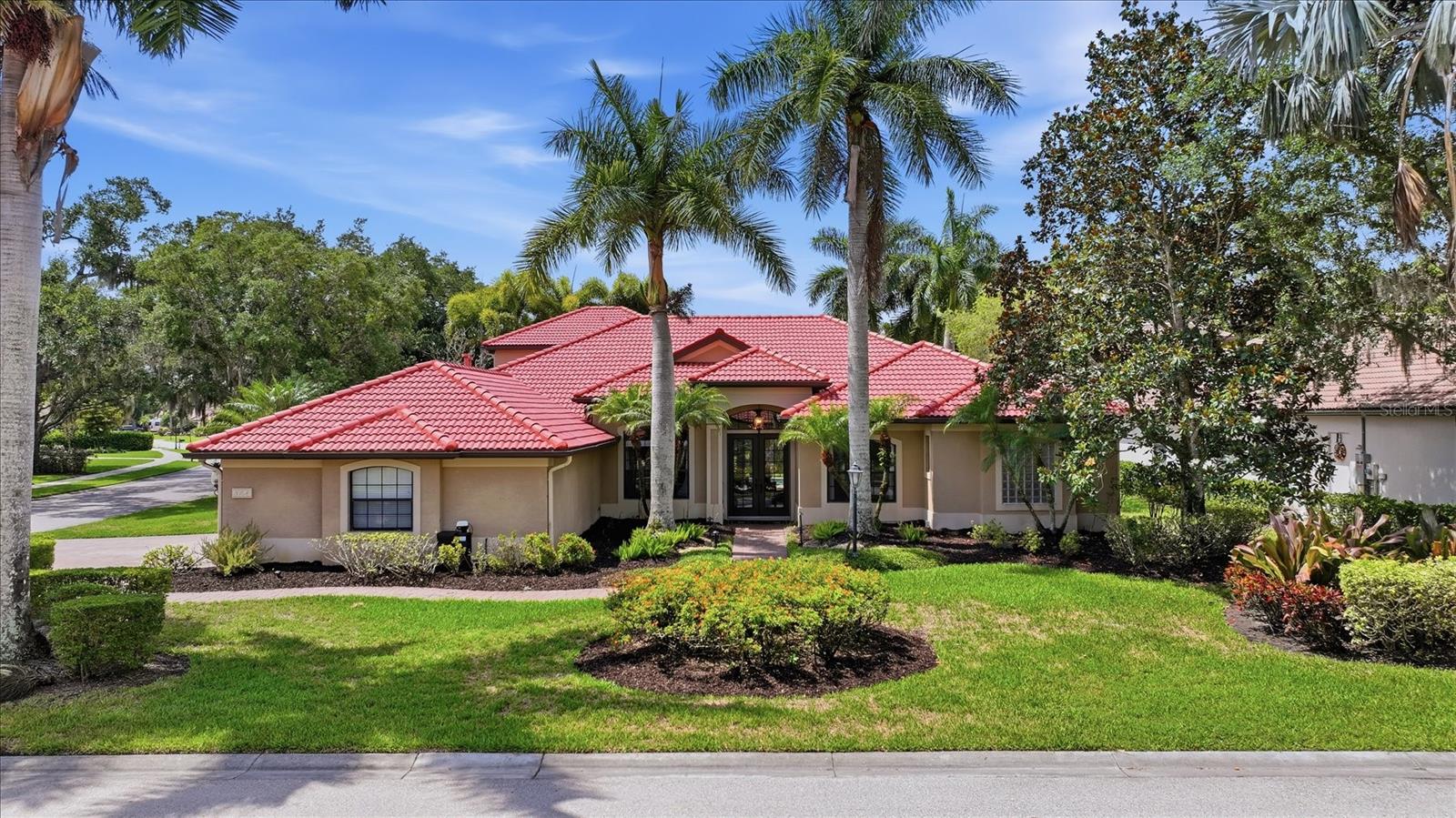 Nestled on a premium corner lot in the highly sought-after gated community of The Hammocks, this meticulously maintained custom-built Tivoli home offers the perfect blend of luxury, comfort, and Florida-style indoor/outdoor living. This exceptional residence showcases pride of ownership throughout. Designed for both elegant entertaining and everyday living, the spacious floor plan features 5 bedrooms, 4 bathrooms, a private den/study, and a large bonus room. The split-bedroom layout provides ideal privacy for family and guests, while crown molding, and numerous designer upgrades create a refined atmosphere throughout the home. The gourmet kitchen is a chef’s dream, complete with granite countertops, upgraded cabinetry, natural gas stainless steel cooktop, wall oven, and abundant prep and storage space. The luxurious primary suite serves as a private retreat with a spacious sitting area, custom walk-in closet cabinetry, and a spa-inspired bath featuring a Roman walk-in shower and oversized soaking tub. Upstairs, guests or extended family will appreciate the private bonus room, additional bedroom, and full bath — an ideal setup for multigenerational living or visiting guests. Step outside to experience true Florida living. The expansive outdoor entertaining area includes dual covered lanais, a fully equipped updated outdoor kitchen & hood, pool bath, outdoor shower, and a beautifully renovated saltwater pool and spa with a new natural gas heater (2025). Relax while enjoying peaceful preserve views and frequent wildlife sightings year-round. Additional highlights include: Side-entry 3-car garage, Paver driveway and walkway,Double-door entry with welcoming foyer, Built-in surround sound and ceiling speakers, Electric fireplace, Laundry room with utility sink, Irrigation well for yard, Large 15,517 SF corner lot, No CDD fees and low HOA dues. Current owners have invested over $180,000 in recent updates and improvements, including: New tile roof (2026), Two new A/C systems (2023) and one additional A/C (2025), Renovated saltwater pool & spa, Updated irrigation system & controller (2026), Water softener system, New natural gas water heater with recirculating pump (2022), New flooring,  Fresh interior & exterior paint, Outdoor lighting system.