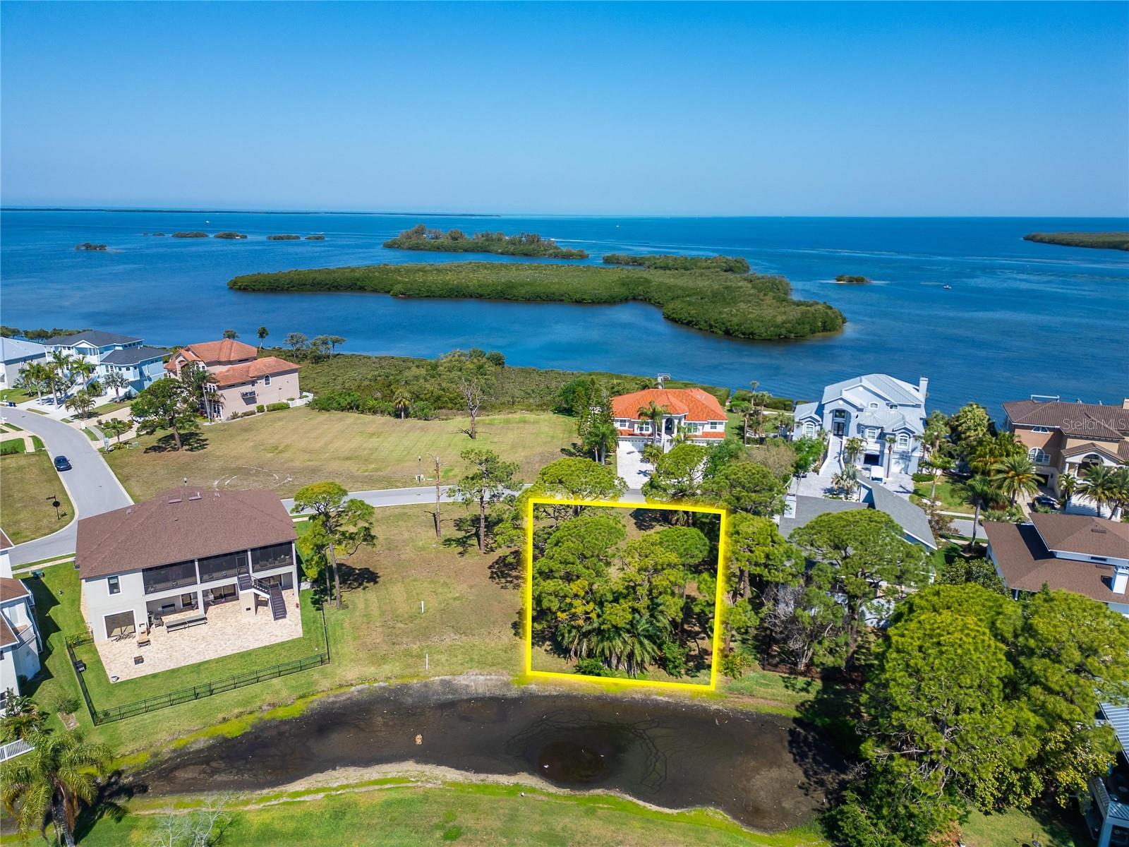 Build your dream home on Lot 106 in the exclusive, guard-gated waterfront community of Harbour Watch, where privacy, natural beauty, and coastal living come together. This approximately .22-acre homesite is ideally positioned with a desirable southeast-facing orientation, offering tranquil views of the pond, lake, and surrounding wetlands—creating a peaceful and picturesque backdrop for your future home. For those looking to maximize the setting, building a second or third story opens the door to potential Gulf views from a northwest-facing balcony, delivering the best of both sunrise and sunset perspectives.

For added flexibility, Lot 107 is also available and can be purchased together, providing an opportunity to create a larger homesite with even more design possibilities.

Harbour Watch is a thoughtfully planned community of just 184 homes, set on a stunning 90-acre peninsula at the northern tip of Pinellas County, bordered by the Gulf of Mexico and the Anclote River. Residents enjoy a true resort-style lifestyle with amenities that include a clubhouse with fitness center and gathering spaces, a junior Olympic-size pool and heated spa, lighted tennis courts, a playground, and a Gulf-side fishing pier. Spend your evenings at the community dock or gazebo taking in breathtaking sunsets, or enjoy the peaceful coastal surroundings year-round.

Located just minutes from area beaches, the famous Tarpon Springs Sponge Docks, local dining, shopping, and top-rated schools, this location offers both convenience and charm. Outdoor enthusiasts will also appreciate easy access to the Pinellas Trail for biking, walking, and running.

With 24/7 security and the freedom to choose your own builder, Lot 106 is ready for you to bring your vision to life. Don’t miss this opportunity to secure your place in one of North Pinellas County’s most desirable waterfront communities.