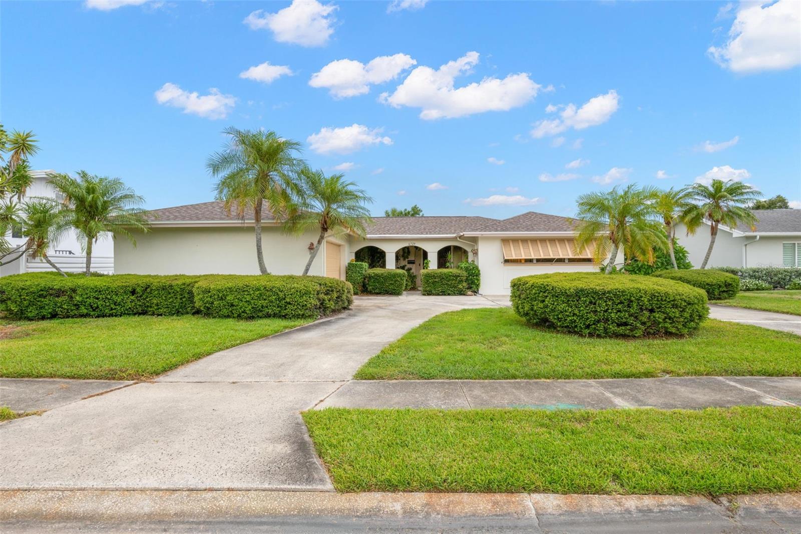 Experience the best of Florida living in this beautifully maintained home overlooking the 17th green of Seminole Lake Golf & Country Club. Tucked away on a quiet cul-de-sac, this exceptional property offers comfort, privacy, and peace of mind with a brand-new roof and a history of never flooding.

A charming covered entry, surrounded by tropical landscaping and a tranquil fountain, welcomes you home. Solid wood double doors open into a spacious foyer with sightlines through the living area to the screened lanai, backyard, and picturesque golf course beyond.

Designed for both everyday living and effortless entertaining, the open kitchen and family room feature newer luxury vinyl wood plank flooring, plantation shutters, breakfast bar, oversized pantry, lovely view of the golf course, and a sliding glass door that leads directly to the screened lanai. The expansive living and dining room next door are filled with natural light, thanks to fully collapsible sliding glass doors that seamlessly blend indoor and outdoor living.

The home has a desirable split-bedroom floor plan with pocket doors in hallway for additional privacy, making it ideal for family or visitors. The spacious primary suite features a walk-in closet, attached bath with vanity, built-ins, and walk-in shower, and a bonus mini-split AC. Two generously sized bedrooms and an updated hall bathroom are located on the opposite side of the home. 

Additional highlights include an oversized indoor laundry room with abundant cabinetry and storage, as well as a spacious garage with an extended workshop area and utility sink. The fully fenced backyard is surrounded by lush, mature landscaping, creating a peaceful setting to relax or entertain while enjoying beautiful golf course views. 

Lovingly maintained by only two families since it was built, this home is truly move-in ready. Conveniently located just minutes from shopping, dining, entertainment, and the Gulf beaches, this is your opportunity to own a private golf course retreat in one of the area's most desirable communities.