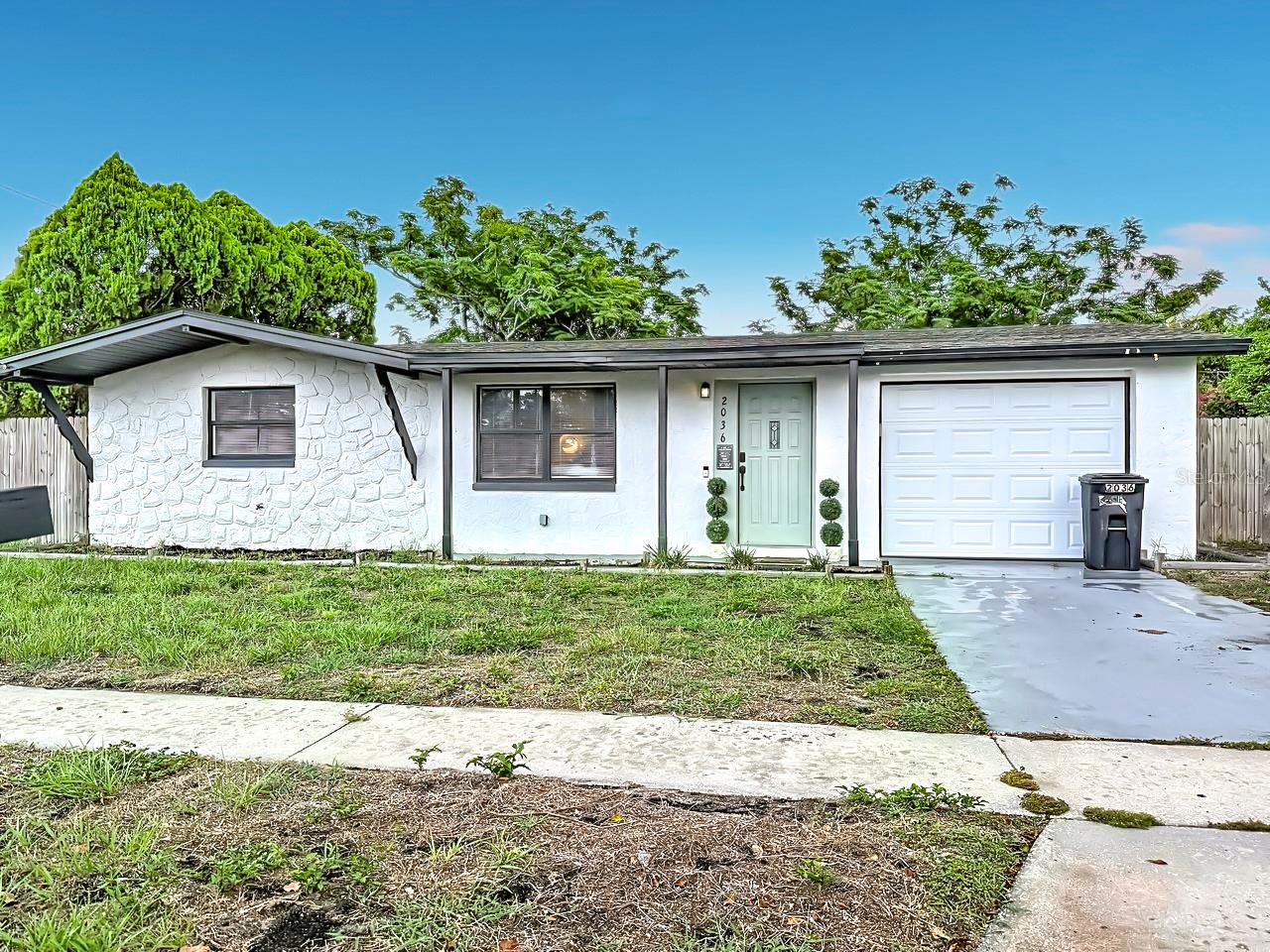 NO HOA. NO CDD. NO FLOOD ZONE. This cozy 2 bedroom 1 bath SMART home, located in the Holiday Gardens is waiting for you. Great starter home. 2023 ROOF, 2023 HVAC, 2023 ELECTRICAL PANEL, 2023 WATER HEATER, and NEW GARAGE DOOR. Open floor plan with renovated kitchen, bathroom, and LVP flooring throughout the home. Up-to-date with the latest technology including a Ring Doorbell, SmartLock, and Nest Thermostat. Front and back lawns are well-maintained with St. Augustine grass. Backyard is fully fenced-in and ready for your personal creation. This open space is low maintenance and perfect for entertaining inside and out, while enjoying the year-round Florida Sunshine. Conveniently located east of US-19, the property offers great proximity to beaches, shopping, dining, and entertainment.  Easy access to major roads and highways, facilitating easy travel to nearby attractions and hidden gems
. Schedule your showing today!