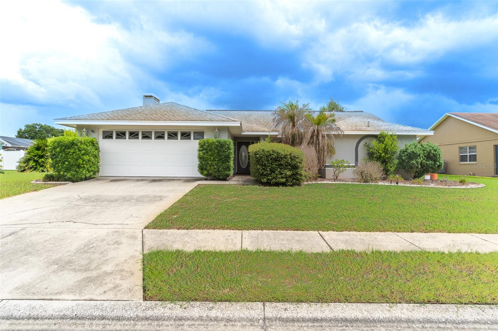 Welcome to your own private oasis in the highly desirable Hunters Run community of North Lakeland! Situated on an oversized lot of more than a quarter acre, this beautifully maintained 3-bedroom, 2-bath home offers the perfect blend of comfort, space, and classic Florida living. Step inside to discover an open and airy floor plan featuring soaring vaulted ceilings, abundant natural light from large windows, and a cozy wood-burning fireplace that serves as the centerpiece of the spacious living room. The thoughtfully designed split-bedroom layout provides privacy, while the formal dining room features sliding glass doors that open directly to the pool area, creating an ideal setting for indoor-outdoor entertaining.

The well-appointed kitchen is a chef's delight, boasting a breakfast bar, tray ceiling, ample counter space and cabinetry, and a convenient pass-through window to the covered deck and screened porch. The expansive primary suite is a true retreat, complete with private sliding glass doors to the pool, dual walk-in closets, and a luxurious en-suite bathroom featuring a Jacuzzi tub, separate shower, split vanities, and a private water closet.

Step outside to enjoy Florida living at its finest with a large covered patio leading to a sparkling screened-in inground pool, all surrounded by a spacious backyard with plenty of room for pets, gardening, or simply relaxing in your own secluded sanctuary. The attached two-car garage adds convenience and extra storage.

Ideally located in North Lakeland, this home is just minutes from shopping and dining along US Highway 98 and the Lakeland Square area, with easy access to Interstate 4 for convenient commuting to both Tampa and Orlando. Nearby parks, medical facilities, and highly rated schools add to the appeal, while world-famous attractions, beaches, and Central Florida destinations are all within an easy drive. This exceptional property offers the perfect combination of privacy, comfort, and an unbeatable location.