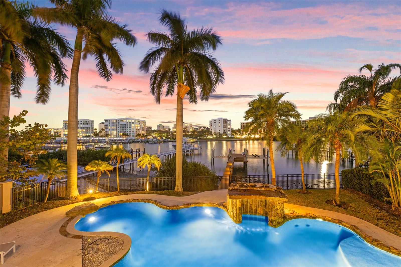 Experience an extraordinary expression of island elegance in this exquisite waterfront residence, nestled within Pinellas County’s most exclusive gated community. Home to fewer than 30 fortunate residents, Belleview Island offers a serene escape that combines unparalleled security, privacy, and breathtaking water views. A short stroll away lies the renowned Belleair Country Club—featuring two 18-hole Donald Ross-designed golf courses, Har-Tru tennis courts, pickleball courts and a junior Olympic-sized swimming pool. The ideal spot for boating enthusiasts, this premier waterfront location provides swift access to Clearwater Pass and the open Gulf waters. Marvel at panoramic water views that serve as the backdrop for the home’s timeless design, exemplifying understated elegance and open-concept living. From the moment you step into the grand foyer, you’ll be captivated by soaring ceilings that elevate every gathering. The gourmet kitchen, outfitted with striking quartz countertops and stainless-steel appliances, accommodates both formal and informal dining with abundant seating. Completing this level are a spacious family room, a formal dining room, and an executive home office—perfect for those who blend luxury living with professional pursuits. Ascend the marble staircase, or opt for the private elevator to reach the lavish primary suite, which boasts a spa-inspired bathroom, a generous walk-in closet, and two balconies overlooking the backyard. An adjoining 14' x 20' room allows flexibility for a nursery, second study, or home gym, catering to your evolving needs. Step outside to one of several balconies, ideal for savoring morning coffee or al fresco dining against a backdrop of idyllic water vistas. The show-stopping 60' x 28' pool is arguably the largest on Belleview Island, offering endless fun in the Florida sun, while a private dock equipped with lifts for two vessels ensures seamless access to your water adventures. This magnificent home is custom tailored for those seeking both refined entertaining spaces and a serene retreat, where every aspect is designed to fulfill the demands of a discerning lifestyle.