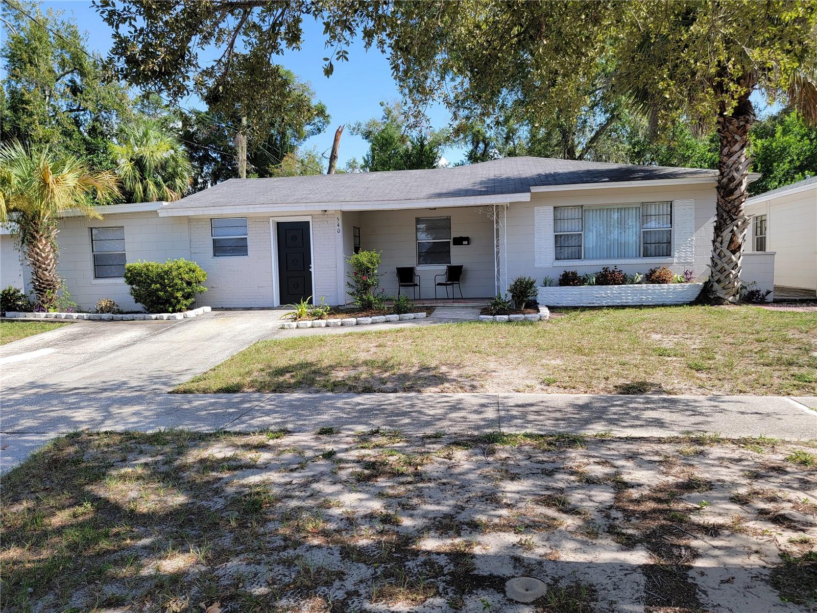 Discover the perfect opportunity to live, invest, or generate rental income with this unique property featuring two beautifully remodeled homes and a 29' x 22' detached concrete block storage building on one lot. Whether you choose to live in one home and rent the other, or maximize your returns by leasing both, this property offers incredible flexibility.  The larger residence features 4 bedrooms, 2 bathrooms, and 1,679 square feet of living space. Inside, you'll find a spacious living room, separate family room, inside laundry, and a stunning new kitchen complete with new cabinetry, countertops, and appliances. Luxury vinyl plank flooring flows throughout the home, complemented by fresh interior paint and new ceiling fans.  The second home offers 2 bedrooms, 1 bathroom, and includes a single-car garage with an adjoining storage/laundry room featuring washer and dryer hookups. Like the main home, it has been completely remodeled with luxury vinyl plank flooring, fresh paint, new ceiling fans, and a beautifully updated kitchen with new cabinets, countertops, and appliances.  Adding even more value is the detached 29' x 22' concrete block storage building, complete with electricity and a half bath—ideal for a workshop, hobby space, business storage, or additional flex space.  Conveniently located in the heart of Lakeland, this property is just a short walk to both Lake Hollingsworth and Lake Morton, offering easy access to scenic walking trails, parks, and all the charm of central Lakeland.  Don't miss this rare opportunity to own a move-in-ready, income-producing property in one of Lakeland's most desirable locations!