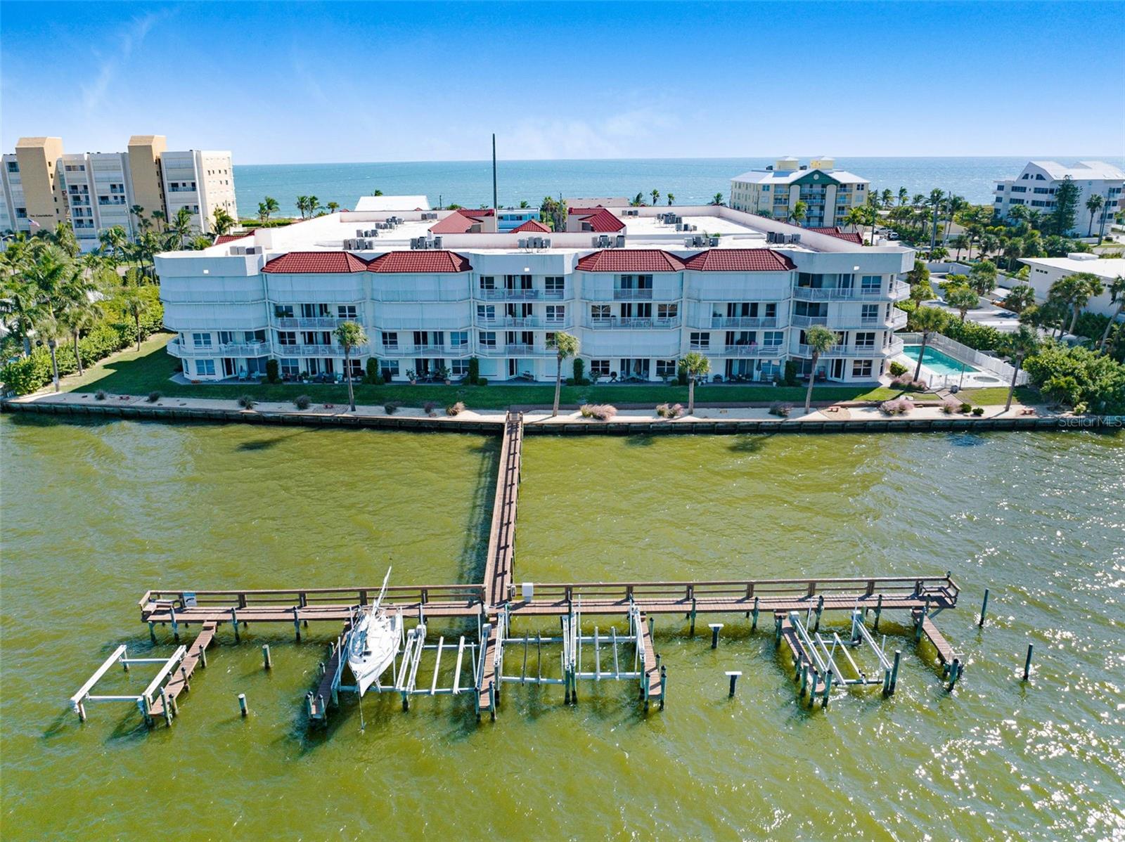 One or more photo(s) has been virtually staged. Welcome to The Topless Turtle -- A Riverfront Retreat Unlike Any Other Experience the perfect blend of luxury, relaxation, and coastal living in this spectacular riverfront condominium nestled in the highly sought-after River Bend community of Cocoa Beach. Overlooking the serene Banana River, this exceptional residence offers breathtaking water views, refreshing ocean breezes, unforgettable sunsets, and front-row seats to Florida's world-famous rocket launches. The sheltered south-facing balcony offers the perfect blend of comfort and scenery, showcasing views of both the Atlantic Ocean and the Banana River. Designed to capture refreshing coastal breezes while providing protection from the intense afternoon sun, this inviting outdoor space can be enjoyed year-round. It's also an ideal setting for cultivating herbs, flowers, and potted plants, creating your own private coastal garden retreat. Thoughtfully designed for modern living with an expansive open floor. 
The beautifully appointed kitchen flows seamlessly into the living space and features a wraparound breakfast bar, chef's pantry with additional freezer and storage, induction stove, newer refrigerator, and abundant cabinetry. Entertain in style with a custom built-in bar complete with a beverage refrigerator and wine cooler. Retreat to the luxurious primary suite where tranquility awaits. Enjoy private balcony access, dual walk-in closets, double vanities, a soaking tub, and an oversized walk-in shower that creates a true spa-like experience. Additional features include generously sized guest bedrooms, secure underground parking, a brand-new roof, 2022 condenser, and 2019 water heater. The HOA provides exceptional value by covering roof and exterior maintenance, water, trash, pest control, pool, spa, fitness center, meeting room, and even a dedicated car wash area. Exciting community enhancements are already planned, including fresh exterior paint and a beautifully remodeled lobby featuring new flooring, furnishings, and finishes. Outside, embrace a resort-inspired lifestyle with a sparkling riverfront pool, fishing dock, scenic boardwalk, and easy access to Cocoa Beach's shopping, dining, entertainment, and pristine beaches. Conveniently located near Melbourne Orlando International Airport, this maintenance-free waterfront sanctuary offers the best of Florida's Space Coast lifestyle. Whether you're searching for a primary residence, seasonal getaway, or luxury waterfront escape, The Topless Turtle delivers an extraordinary opportunity to live where every day feels like a vacation. Schedule your private showing today and discover why this is one of Cocoa Beach's most captivating riverfront residences.