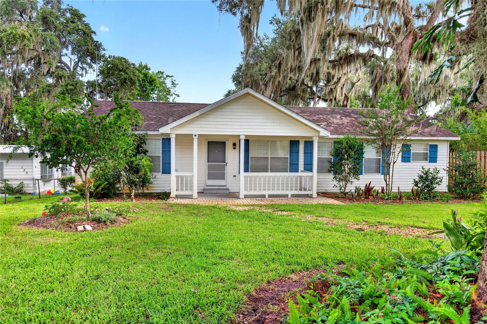 Escape to peaceful lakefront living in this beautifully maintained 3-bedroom, 2-bathroom home nestled along the shores of Little Orange Lake in Hawthorne. Offering the perfect blend of privacy , functionality, and outdoor enjoyment. From the moment you arrive, you'll be welcomed by a charming covered front porch, mature landscaping, and a majestic oak tree that creates incredible curb appeal. The fully fenced property is thoughtfully designed and includes an irrigation system, whole-house water filtration system, and two above-ground planter boxes. There is also two storage sheds on the property for all your gardening, hobby, and storage needs. Inside, the split-bedroom floor plan provides privacy and comfort. The spacious primary suite features a large bathroom complete with a soaking tub, separate walk-in shower, and abundant storage. The galley-style kitchen offers plenty of cabinetry and countertop space, along with a cozy dining area perfect for everyday meals. Outdoor living takes center stage with a screened lanai, expansive deck constructed of marine-grade wood, and a long private dock stretching into Little Orange Lake. Perfect for fishing, boating, wildlife, or simply taking in breathtaking waterfront views. Little Orange Lake is part of the larger Orange Creek Basin watershed with canal connections to Holdens Pond and Moss Lee Lake, offering exceptional opportunities for recreation and exploration. This property is conveniently located approximately 30 minutes from Gainesville and under an hour from Ocala, making it an ideal retreat without sacrificing access to shopping, dining, and everyday conveniences. Whether you're searching for a full-time residence, weekend getaway, or lakefront retreat, this property delivers the Florida lifestyle you've been dreaming of. Schedule your private showing today!