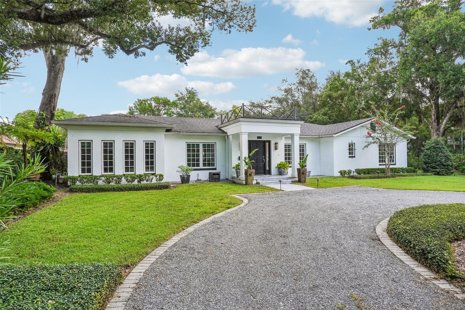 This WINTER PARK POOL HOME is set on a corner lot with entrances from both Palmer Avenue and Temple Drive. Located within Winter Park's exclusive J Kronenberger community, this luxury property is tucked away approximately a half mile to Winter Park's YMCA, Phelps Park & the lovely Kraft Azalea Garden, and approximately 1.5 miles to Park Avenue's restaurants, boutiques and farmer's market. The floor plan offers 4 bedrooms, 4.5 bathrooms & a home office/bonus room. The bedrooms are organized in a triple split plan arrangement that frames the open-concept gathering areas. Three bedrooms have private ensuite bathrooms, the 4th bedroom is placed directly next to the hall bath, and the office/bonus room sits adjacent to the guest half bath...everyone has a bathroom! Multiple exits lead out to the backyard, seamlessly merging the indoor and outdoor spaces. Mature hedges provide natural privacy for the open-air pool, spacious pool deck and backyard lawn. Additionally, a backyard paver path provides access to the property's 2-car detached garage. There is plenty of parking for year-round entertaining with the front half circle drive and the rear 2-car garage with multi-car driveway. This home uses natural gas to fuel the range, tankless water heater and outdoor firepit on the pool deck. Recent updates include outdoor perimeter lighting, rear fence, privacy hedges & irrigation.  Prime real estate within Winter Park’s historic tree-lined streets.