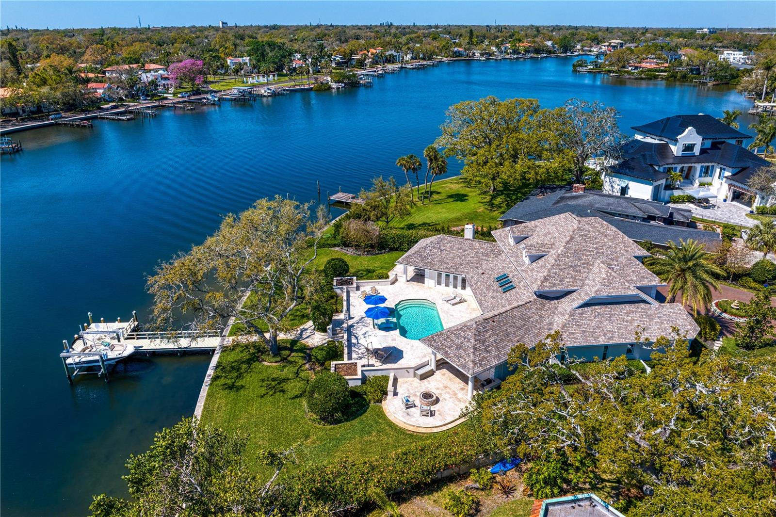 Rare Waterfront Gem on Snell Isle – Unmatched Views & Prime Location
Situated on one of the larger waterfront lots in Snell Isle, this breathtaking estate is located on the highly sought-after Coffee Pot Riviera, a private, brick-lined cul-de-sac. Spanning just over a half of an acre with 165+ feet of waterfront on a 200+ feet deep lot, this concrete block home offers an unparalleled blend of luxury, space, and the true Florida lifestyle. Exceptional Design & Layout!  From the moment you step inside, you’ll be captivated by the stunning panoramic water views, visible from nearly every room. The 14-foot ceilings on the first floor create an open, airy ambiance, while the thoughtful floor plan seamlessly blends indoor and outdoor living. The outdoor space is unmatched, featuring:
• A sprawling backyard with plenty of room for people, parties, pets, or even a private soccer or volleyball field. ;)
• A huge pool deck with a covered dining area, ideal for entertaining.
• A cozy firepit, perfect for cool Florida evenings.
• A boat lift and large dock, ideal for manatee and dolphin watching or launching your boat.
• A covered outdoor living space with wood plank inlay, seamlessly extending from the family room for year-round enjoyment.
Smart, Spacious Living
The home’s versatile layout offers privacy and functionality, with:
• A primary suite on the first floor, along with a second bedroom (or office) and full bath.
• Additional guest bedrooms upstairs, plus double desks, a library, or office space—perfect for remote work or study.
Meticulously Maintained with Modern Updates
This home has been thoughtfully upgraded, ensuring peace of mind for years to come:
• Roof: 2014
• HVAC systems: 2022, 2024, and 2015
• Tankless hot water heater: 2024
• Kitchen appliances: 2021
• Washer/dryer: 2024
• Pool retiled & extended: 2018
• New pool heater/chiller: 2025
• Pool pump: 2018
• New 1st-floor flooring: 2022
• Hurricane windows & doors: 2018
• Dock & lift: 2015 | Dock pilings wrapped: 2020
• Seawall: 2017
• Sprinkler system: 2024
• Whole house painted: 2021
All of this, just a short walk along the waterfront sidewalk to downtown St. Pete, where you can enjoy world-class dining, shopping, and entertainment.  Don’t miss this rare opportunity to own a one-of-a-kind waterfront estate in one of St. Petersburg’s neighborhoods.