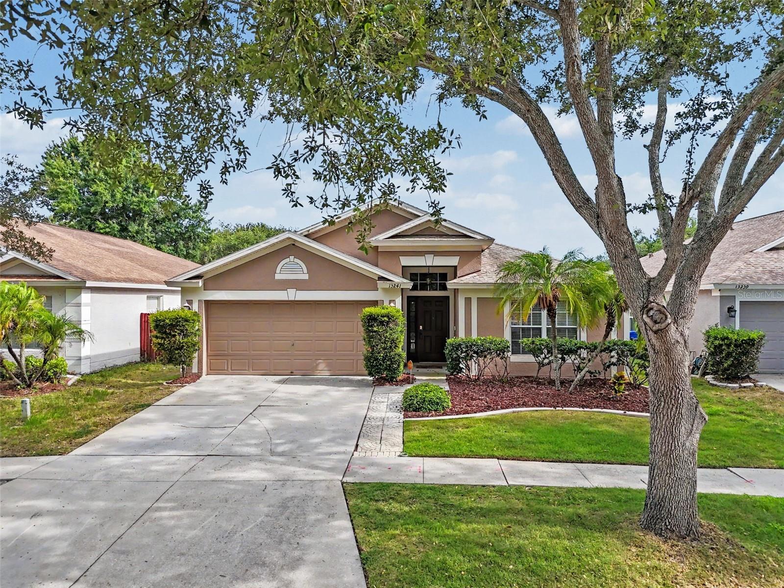 Welcome to this beautifully maintained 3-bedroom, 2-bathroom home in Riverview, featuring major system updates and numerous outdoor and landscaping improvements completed in 2025. With over $43,000 invested in major upgrades, including a $15,586 roof replacement (2021), $12,460 HVAC system (2017), $2,800 laminate plank flooring installation (2021), plus a 2018 water heater, $5,792 vinyl fence, $4,764 irrigation system, and $2,537 landscaping refresh, this home offers exceptional value and peace of mind. Designed with a desirable split floor plan and open-concept layout, the home showcases warm laminate flooring, crown molding throughout, and vaulted ceilings. The spacious living room, dining area, and kitchen flow seamlessly together, creating the perfect setting for everyday living and entertaining. The kitchen features granite countertops, abundant prep space, wood cabinetry, a breakfast nook, and a separate pantry for additional storage and organization. Privately situated on one side of the home, the primary suite offers high ceilings, a ceiling fan, a walk-in closet, and an en-suite bathroom complete with a double-sink vanity, soaking tub, separate glass-enclosed shower, and private water closet. Two additional bedrooms are nicely sized, each with ceiling fans, and share a full bathroom with a tub/shower combination. Step outside to enjoy Florida living year-round from the covered, screened lanai. Beyond the lanai, a patio provides additional space for outdoor dining, grilling, or relaxing, while the spacious backyard offers plenty of room for gardening, play, or furry friends. Recent exterior improvements include a new vinyl fence, irrigation system, and refreshed landscaping, creating an inviting outdoor retreat. Residents enjoy access to community amenities including a pool, playground, and sports courts. Conveniently located near I-75, this home provides easy access to shopping centers, restaurants, parks, a movie theater, and everyday conveniences while remaining within commuting distance of Tampa and surrounding areas. Schedule your showing today and discover everything this Riverview home has to offer.