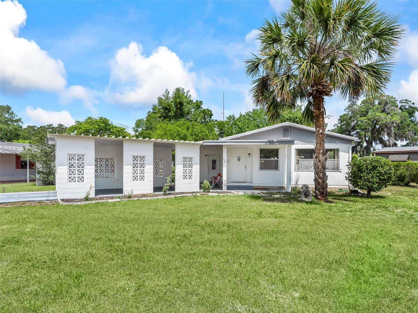 Well-maintained 2-bedroom, 2-bath double wide in the community of Oak Park Village. Recent updates include a new roof (2024), new A/C (2024), new water heater (2025), updated flooring (2025), new exterior back door, and all-new kitchen appliances. Features a new breezeblock carport, storage area, a Florida room, and small workshop space as well! Don't miss out on this AMAZING opportunity!!