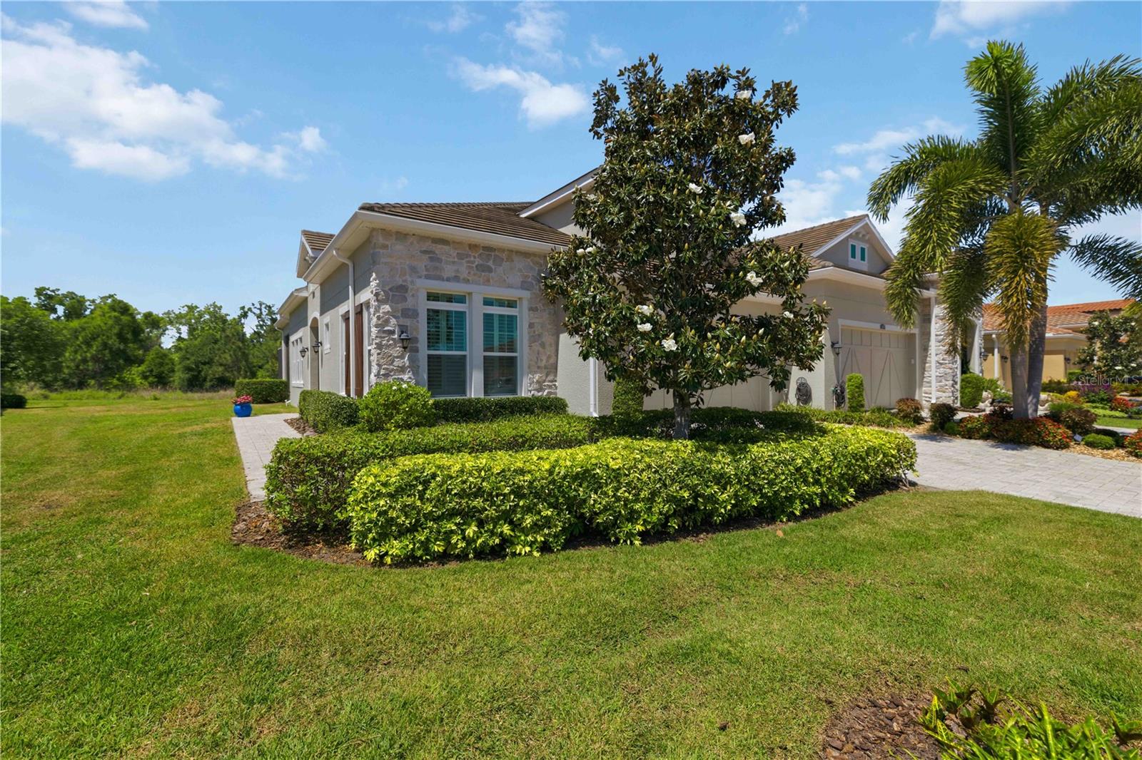 Welcome to an exceptional residence in the gated Arbor Grande of Lakewood Ranch, where timeless design and modern sophistication come together in perfect harmony. Crafted by CalAtlantic, this beautifully appointed 2-bedroom, 2-bath + office villa offers an elevated lifestyle defined by elegance, comfort, and ease. Feels like, Condo living in a Villa community. Adding to the appeal is a truly maintenance-free lifestyle, with the HOA providing exterior maintenance, landscaping, and yard care—allowing you to focus on what matters most, a serene well maintained community and home. 

From the moment you enter, you are greeted by stunning plantation shutters, soaring 10-12-foot ceilings, refined tray details, custom accent walls and a seamless flow of natural light through expansive sliding glass doors crowned with transom windows. Bright inviting porcelain tile flooring extends throughout the home, creating a bright, cohesive aesthetic, while custom accent walls in the great room and primary suite add depth and designer character.

At the heart of the home, a thoughtfully designed kitchen showcases quartz countertops, 42 inch upper cabinetry, spacious island and gas cooktop—perfectly positioned to connect with the dining and great room spaces for effortless entertaining. 

The owner’s suite is a serene retreat, featuring elegant tray ceilings, a striking accent wall, and a spa-inspired bath complete with dual vanities and a frameless glass shower. (The fireplace in primary bedroom picture does not convey.) A private enclosed den with barn doors offers versatility as a functional home office or welcoming guest space. Carefully selected light fixtures and ceiling fans throughout the home also adds to the charm

Step outside to your extended screened lanai, where tranquil preserve and nature views provide a peaceful backdrop for everyday living. Pre-plumbed for natural gas, this space is ready to become your dream outdoor kitchen and entertaining haven.  An outdoor grill is included for your outdoor entertainment needs. This homesite enhances both privacy and the connection to nature. Clay tile roof adds extra comfort for long lasting protection from the elements. Seller is also including generator which is currently located in the garage, for any power outages from storms.

Residents of Arbor Grande enjoy a curated collection of amenities including a clubhouse, fitness center, heated pools and spa, pickleball and bocce courts, and a private dog park—all just moments away. With direct access to Bob Gardner Park and close proximity to fine dining, shopping, and the Gulf Coast’s renowned beaches, the location is as desirable as the home itself.

Move in ready, 
All measurements to be verified by buyers and their realtor.