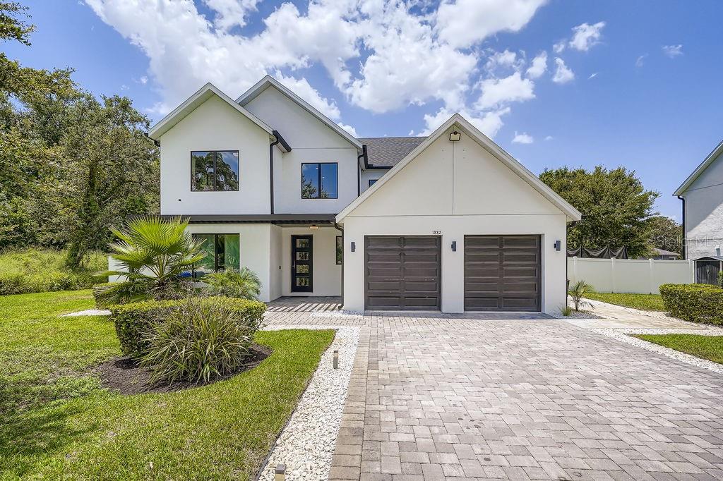 Absolutely Stunning Modern Home with No HOA on Nearly Half an Acre! Welcome to 1882 Lake Pearl Dr in the charming town of Gotha, an exquisite 4-bedroom, 3.5-bath single-family home that perfectly blends modern design with comfortable living. Built in 2021, this property has been meticulously maintained by its original owners and sits at the end of a quiet dead-end street with no through traffic, offering the ultimate in privacy. Inside, you’ll find beautiful fully upgraded flooring, unique wall panels, and a chef-inspired kitchen with elegant custom cabinetry, Quartz Countertops, and a beautiful wine cellar. The open layout is bright and inviting, designed to seamlessly accommodate both daily living and entertaining. The home features four spacious bedrooms and three full bathrooms, along with a convenient half bath, providing plenty of space for family and guests. Step outside to enjoy the absolutely gorgeous pool and an expansive lot of nearly half an acre. Only half of the property is cleared, offering endless potential for expansion, gardening, or creating your dream outdoor oasis. With no HOA, elegant curb appeal, and a modern architectural design, this property is truly a rare find.