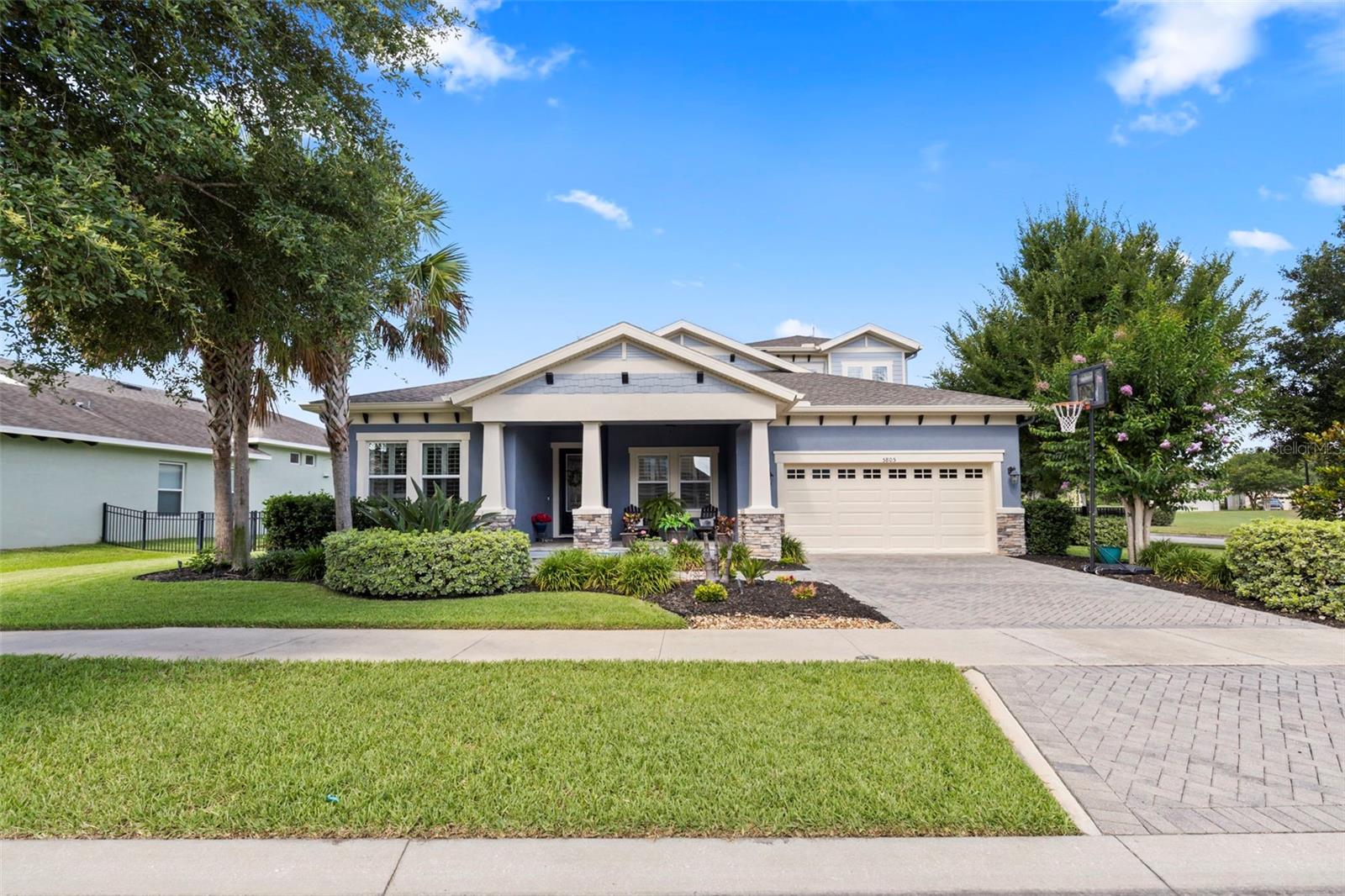 Beautifully built by Homes by WestBay, this 4-bedroom, 5-bathroom pool home on corner lot across from park is now available for tours. Come enjoy the Fishhawk Lifestyle in one of the most popular floorplans... PLUS ROOF was replaced in late 2024. You will love the spacious, bright kitchen with large island, gas range, 42" upgraded cabinets, solid surface counters, desk area, eat-in area, and plenty of space to gather right off the great room (which includes a built-in surround sound system).  A wall of sliding glass doors leads out the covered lanai and gorgeous pool with spa, plus full bath. Back inside there are 4 downstair bedrooms, and an office suite with bathroom. The large primary suite includes bath with soaking tub as well as separate shower, double vanities, and an upgraded closet system in the massive walk-in closet. Upstairs is another bedroom and bath, plus a bonus/media room! Plantation shutters provide privacy throughout the house.  This home will not disappoint... make sure you put it on your list to discover!