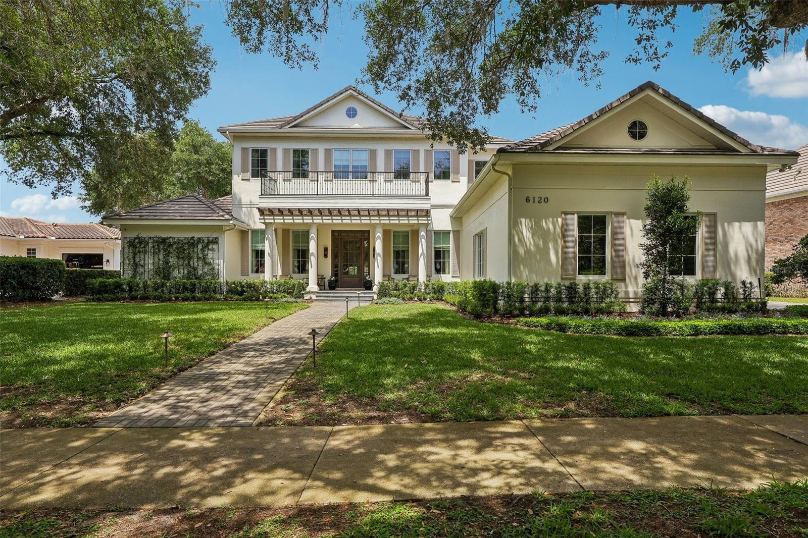 Keene’s Pointe – 24-hour gated/attended community in Windermere, Florida.  Experience refined luxury in this exceptional golf-front estate perfectly positioned along the 17th fairway of The Golden Bear Club.  Fully renovated, architecturally refined and intentionally designed by Ashley Martin Home.  From the moment you enter, an inviting foyer opens to a spacious living room framed by 12-foot ceilings, expansive windows, and views of the course, filling the home with natural light and warmth, as well as a functional dining room with built-in cabinetry, perfect for entertaining.  Designed with both elegance and functionality in mind, the home features wide-plank hardwood flooring throughout, custom drapery and shades, and extensive upgraded lighting and finishes. The private office is a standout, complete with rich built-in cabinetry and a wood-accent ceiling that creates a sophisticated workspace.  The primary suite is a true retreat, accessed through a private vestibule-style entrance offering a serene escape. Inside, enjoy access to the outdoors, a spa-inspired bath with a freestanding tub, an oversized walk-in shower, and a spacious custom walk-in closet with built-ins.  The chef’s kitchen is thoughtfully appointed with built-in refrigeration and dishwasher, an appliance garage, a large center island, Butler’s pantry with wine refrigeration, and a generous breakfast nook. A mud area with built-ins adds everyday convenience, while the family room showcases custom built-ins for effortless living.  The home offers a versatile and spacious layout, including two ensuite bedrooms with walk-in closets on the main level, and two additional bedrooms upstairs connected by a shared bath. The second floor also features a loft with built-ins that can easily function as a fifth bedroom, playroom or media room, along with a bonus space overlooking the golf course—currently used as a gym, but ideal for a game room or lounge. Outdoor living is equally impressive, featuring a saltwater pool and spa, fire pit, cabana with summer kitchen, and a private putting green. The fenced yard and retractable screened lanai create a seamless indoor-outdoor experience, while a convenient exterior-access half bath serves the pool area.  Additional highlights include a well-appointed laundry room with stacked washer and dryer, and a four-car garage with high ceilings and custom flooring, and much more! This turn-key home can be purchased fully furnished and decorated.  Conveniently located to shopping, dining, expressways, tourist attractions, and top-rated public and private schools, this is a rare opportunity to own a meticulously designed, luxury estate that blends comfort, style, location, and stunning golf course views into one extraordinary residence.