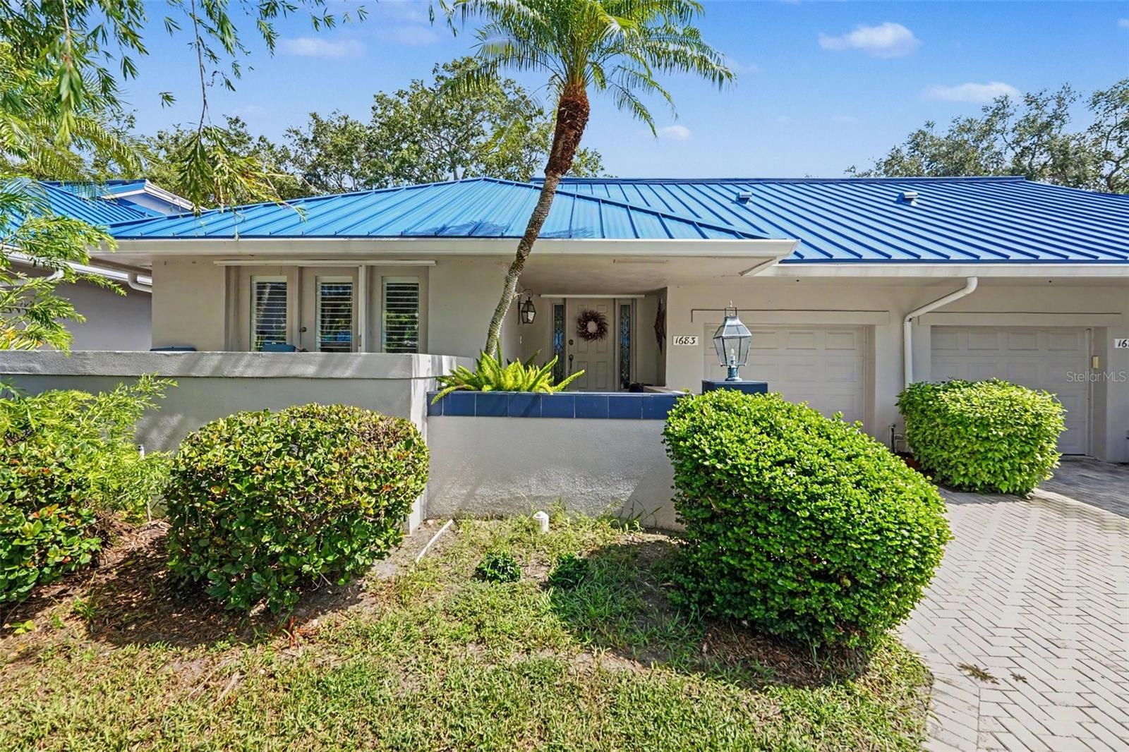 Virtually Staged. Experience premium villa-style living in Watermark—a quiet, upscale waterfront community located on a deep-water canal with quick access to Tampa Bay. Residents enjoy a true coastal lifestyle complete with a waterfront boardwalk, a 2015 seawall, and a community dock offering kayak and paddleboard access to Weedon Island's nature channels. This rare, multi-level home offers the ultimate peace of mind: absolutely no history of flooding or water intrusion to the home, full protection with hurricane impact windows and custom Bahama shutters, and the lock-and-leave convenience of a condo, as the association handles all exterior building maintenance—including a brand-new metal roof installed in 2024. Your low-maintenance lifestyle is fully supported by an HOA that covers building insurance, cable, high-speed internet, trash, water, and grounds maintenance. Inside, you'll find a bright, open floor plan highlighted by a cozy fireplace and a completely renovated kitchen featuring a spacious center island and a wine fridge. For maximum comfort and convenience, the primary bedroom suite is located on the first floor. Outside, relax on your private oversized paver patio offering peaceful views—a true private oasis perfect for morning coffee or evening relaxation. Additional functional features include a garage with a storm-reinforced door, EV/generator outlet, and attic storage, plus a dedicated carport. Located in a pet-friendly neighborhood just steps from local schools, a golf course, and the YMCA, this unbeatable location puts you only minutes from 4th Street dining, vibrant downtown St. Pete, and a quick 20-minute commute to Tampa International Airport. Whether you are seeking an effortless primary residence or a lock-and-leave seasonal getaway, this gorgeous waterfront villa delivers exceptional value!