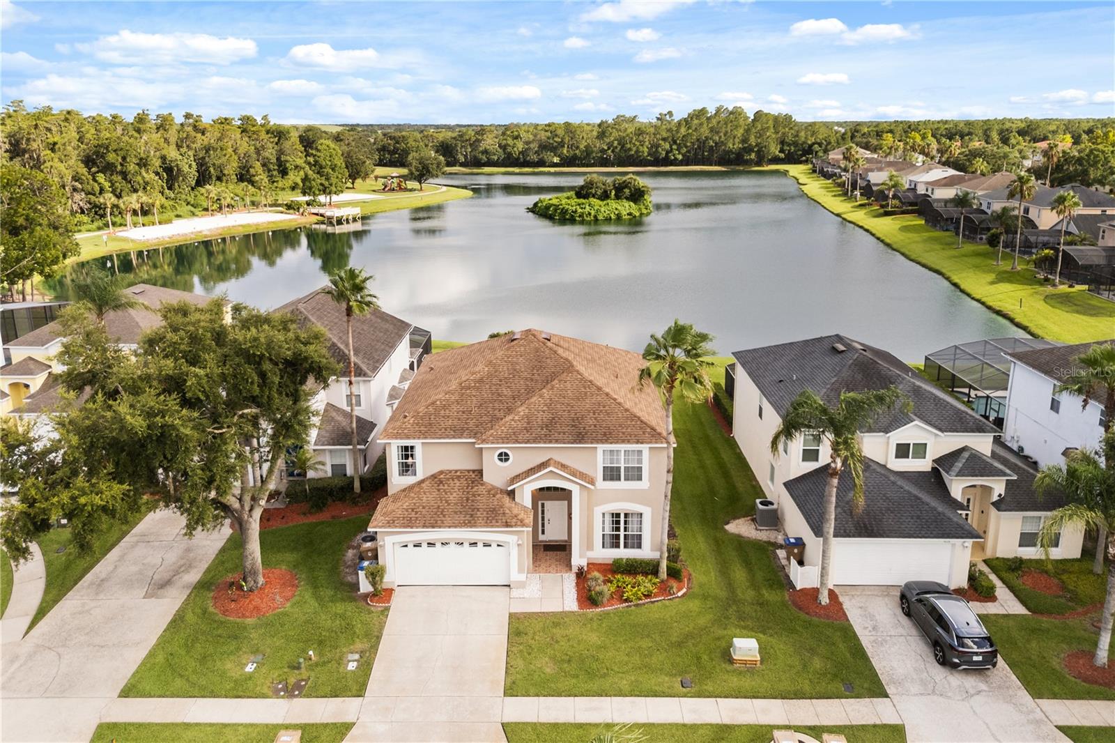 **Waterfront, fully renovated, and partially furnished, this exceptional 7-bedroom plus office pool home offers the perfect combination of luxury, space, and investment potential in the highly sought-after Lake Berkley Resort.**

Situated on a premium south-facing waterfront lot with peaceful pond views and no rear neighbors, this beautifully updated home features a fully remodeled open-concept kitchen with quartz countertops, custom cabinetry, a large center island, wine cooler, and newer appliances. Additional upgrades include laminate flooring throughout, crown molding, upgraded bathrooms, fresh interior and exterior paint, and a dedicated office with French doors.

The spacious floor plan offers two primary suites, including one on the first floor, providing flexibility for large families, vacation guests, or short-term rental use. Outside, enjoy the resurfaced private pool and freshly painted pool deck overlooking tranquil water views.

Select furnishings, décor, televisions, kitchen inventory, and outdoor furniture will convey, making this an excellent opportunity for buyers seeking a move-in-ready primary residence, vacation home, or investment property.

Located within the 24-hour guard-gated Lake Berkley Resort, residents and guests enjoy access to a clubhouse, community pool, fitness center, tennis courts, playground, private beach area, and walking trails—all just minutes from Disney, shopping, dining, and major attractions.

**A rare opportunity to own a beautifully renovated waterfront pool home with room for everyone in one of Central Florida's most desirable resort communities.**