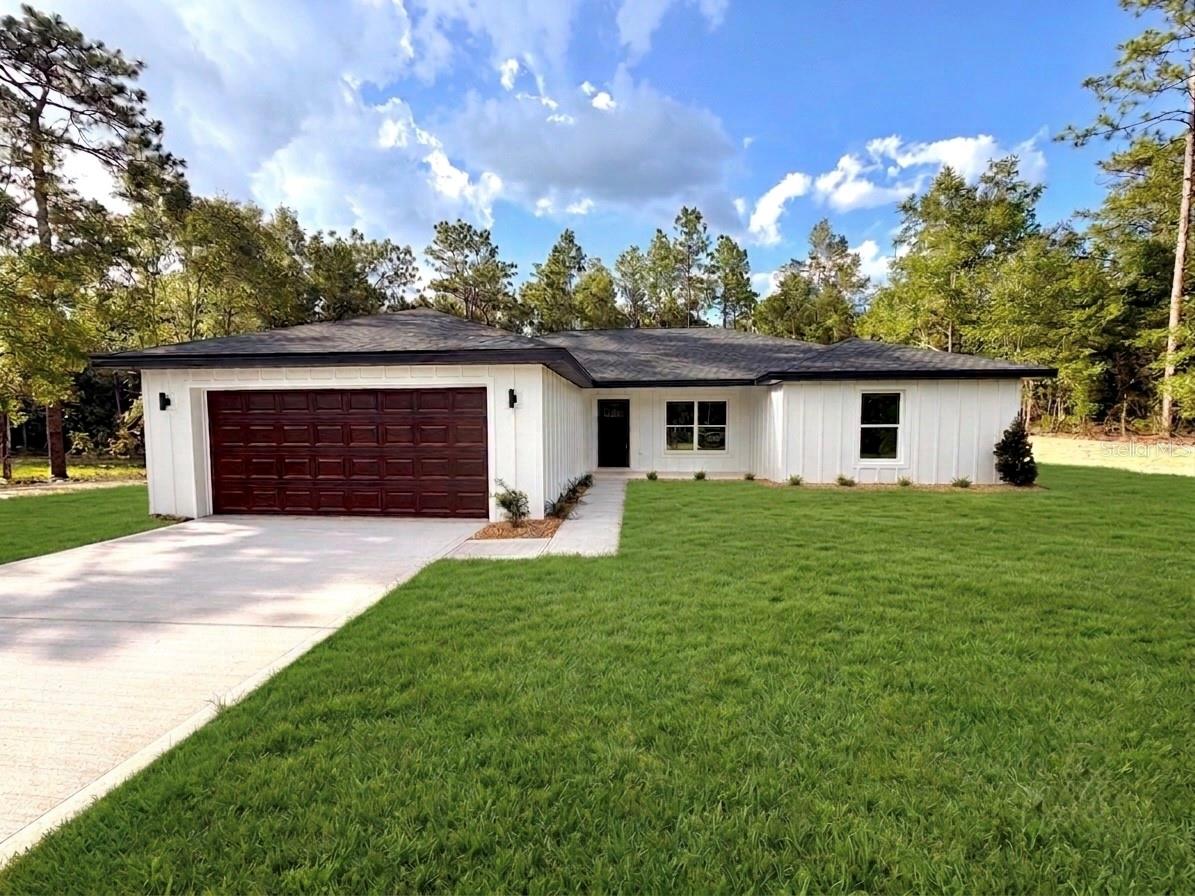 Welcome to your dream home in the desirable Rolling Hills community! Situated on 1.16 private acres and set approximately 75 feet back from the road, this beautifully built 4-bedroom, 2-bath home offers the perfect blend of privacy, comfort, and modern design. Step inside to an open, inviting floor plan featuring stunning 22-mil, 9” x 72” luxury vinyl plank flooring throughout and a beautifully designed kitchen with soft-close shaker cabinetry and bright LED lighting. The versatile third bedroom is perfect for a home office, nursery, or guest room. The spacious primary suite is a true retreat, complete with a deep soaking tub, walk-in shower, and an oversized walk-in closet with plenty of room for custom shelving or even a safe. The additional bedrooms also feature large or walk-in closets, providing exceptional storage space. Built with quality and efficiency in mind, this home includes insulated block walls for improved energy savings, GAF HDZ architectural shingles with a “no wind speed” protection and lastly a Cobra Ridge Vent system to improve attic ventilation and overall efficiency, helping you save on your electric! Outside, you’ll enjoy the peace and privacy of your expansive lot, complete with a 175-foot-deep well and a full irrigation system to keep your lawn and landscaping lush year-round. If you’re looking for a move-in-ready home with premium finishes, energy-efficient construction, and room to enjoy the Florida lifestyle, this one is a must-see!