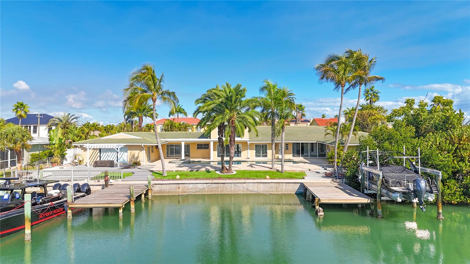 Welcome to your one of a kind waterfront estate in the island community of Vina del Mar situated just off Pass a Grille Beach. Situated on a double lot with 137 feet of direct water frontage with not one but two boat docks! This expansive residence offers the ultimate Florida coastal lifestyle with space, luxury, and unmatched boating access.  Be your own captain with Sailboat and Yacht water right out back with no bridges to hurdle to get to open water.

This 6-bedroom, 5.5-bath stately home is designed for both everyday comfort and large-scale entertaining. A circular driveway provides impressive arrival and ample parking, while the backyard unfolds into a private resort setting. Enjoy a 65-foot saltwater pool perfect for swimming laps, or having your very own pool party while easily accessing the connected hot tub. The ample pool patio and decking offers abundant space for outdoor dining, lounging, sunset gatherings, and large corporate or personal events — all overlooking the water surrounded by lush and tropical Palm trees and foliage.

For boating enthusiasts, the property features two private docks, a 12,000 lb electric boat lift, and quick access to open water — a true boater’s dream.

Inside, the home offers high-end finishes throughout, including premium Sub Zero and Wolfe appliances and a kitchen ready for your own transformation — with professional renderings and contractor quote available for buyers who want to bring their own vision to life. The primary and expansive master suite is a relaxing retreat surrounded with natural light, sliders that lead right to the hot tub, pool, and boat docks, boasting three large closets perfect for your shoe collection, and featuring a glass-enclosed shower and a jetted soaking tub for spa-like comfort.

The 2nd master bedroom and ensuite bath in the East wing also offers natural sunlight with access to the pool/hot tub and docks from the room. The living room offers a wood burning fire place that can be taken in from the Kitchen and large dining room. Right off the living room to the north is a tucked away guest bedroom and full size bathroom. To the north is a brand new full bathroom and office. To the west of the main entrance and foyer is the great room, a perfect room to congregate and make memories while directly to the right are side by side guest rooms and a shared full guest room. When you enter the home your eyes will gravitate to the second floor loft with half bath, perfect for a bedroom, office, yoga/pilates studio with amazing views in every direction. 
The east and west garages offer plenty of room for three vehicles and your very own LSV golf cart to transport yourself from the island to the beach with ease. The washer and dryer located in the east garage is just off the kitchen. 
With an unbeatable waterfront setting, this property presents a rare opportunity to own a premier estate in one of St. Pete Beach’s most sought-after neighborhoods.

Luxury. Space. Boating. Location.
This is waterfront living at its finest.  Seller Financing available, inquire within.