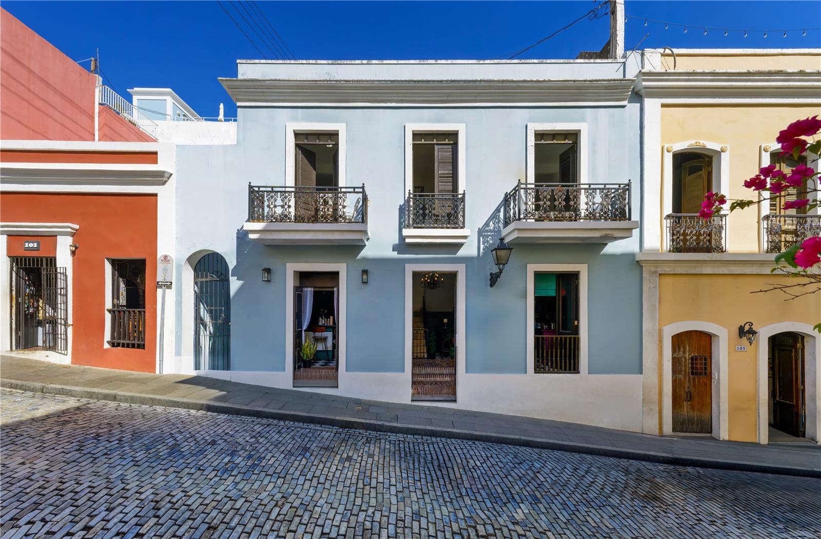 In the heart of historic Old San Juan, 103 Calle Cristo stands as a rare mixed-use gem directly across from Hotel El Convento and near the Cathedral. The building captures the essence of colonial architecture with high ceilings, arched doorways, and wrought-iron balconies overlooking the cobblestone streets. It features two ground-floor spaces, both currently operating as popular taverns, and ten apartments above with a mix of one-, two-, and three-bedroom layouts. This combination provides immediate income potential and long-term flexibility for residential or hospitality use. Surrounded by the city’s most visited landmarks, fine dining, and boutique hotels, the property’s location ensures strong pedestrian traffic and enduring demand. With its architectural charm and prime address, 103 Calle Cristo is an exceptional opportunity to own a full building in one of Puerto Rico’s most prestigious and historic settings. Set just moments away from the majestic Catedral de San Juan Bautista and directly across from the renowned Hotel El Convento, this property enjoys an address of unmatched prestige in the heart of Old San Juan. Calle Cristo is one of the city’s most storied streets. Lined with colonial architecture, cobblestones, and a lively mix of boutiques, cafes, and entertainment venues that keep the area vibrant from day to night. Old San Juan is one of the oldest European settlements in the Americas and a UNESCO World Heritage Site, celebrated for its colorful Spanish architecture and vibrant cultural life. The area blends history and modern vitality. Within its seven-square-block radius, you’ll find centuries-old forts like El Morro and San Cristobal, boutique hotels, fine dining, and lively plazas filled with music and art. It’s a one of a kind community where locals and visitors enjoy visiting cafes, rooftop terraces, and galleries, all framed by ocean views and tropical breezes.