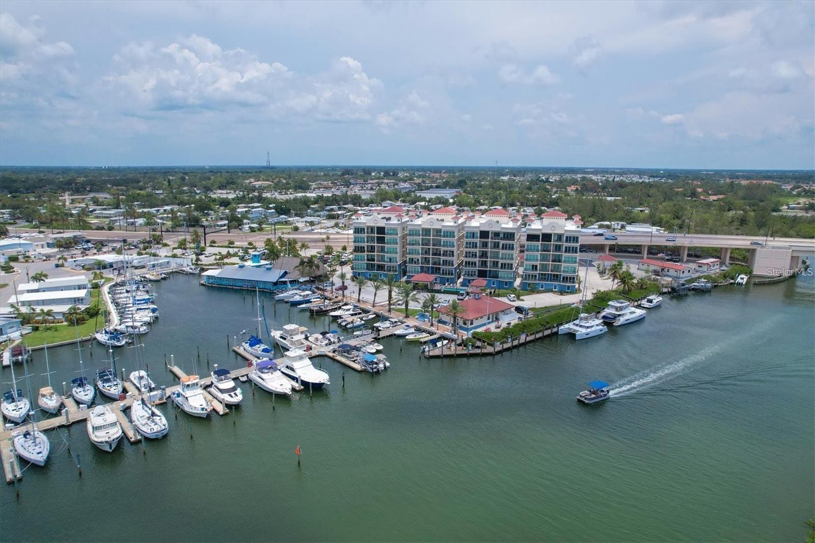 Newly constructed luxury condominium offering breathtaking, unobstructed panoramic views of the Marina, Intracoastal Waterway, and the Gulf of Mexico. Encompassing nearly 2,000 square feet of impeccably designed living space, this exceptional residence seamlessly blends modern elegance with coastal sophistication. Featuring three generously sized bedrooms and two beautifully appointed bathrooms, the home is enhanced by soaring 12-foot ceilings, expansive windows that flood the space with natural light, and an open-concept layout perfect for both everyday living and entertaining. No detail was overlooked in the design and construction of this remarkable property. High-end finishes and thoughtful upgrades are evident throughout, including Timberlake custom cabinetry, Moen faucets and fixtures, Level 4 plank tile flooring throughout the entire residence, 2-panel solid core doors, Sherwin Williams interior paint, and stunning colonial crown tray ceilings that add architectural character. The chef-inspired kitchen is a true centerpiece, complete with GE Profile stainless steel appliances, a stylish Glazzio backsplash, elegant Keiran fixtures, and abundant cabinetry and counter space. Every element reflects quality craftsmanship and timeless design, as the owners spared no expense in creating a refined yet comfortable living environment. The spacious primary suite offers a private retreat with tranquil water views, a luxurious en-suite bath, and ample closet space. The additional bedrooms are equally inviting, ideal for guests, a home office, or a personal fitness space. An oversized private balcony provides the perfect setting to enjoy morning coffee, evening sunsets, or simply relax while taking in the stunning waterfront scenery. This residence also includes a private, two-car enclosed garage located beneath the building, providing added security and convenience, along with ample guest parking for visitors. A fully secured elevator and stairwell offer direct access from the garage level to your designated floor, ensuring both privacy and ease of access. Residents of Porto Vista, a boutique community of only 40 exclusive units, enjoy a peaceful and refined lifestyle in an intimate setting. Resort-style amenities include a heated swimming pool with cabana, a charming poolside gazebo ideal for relaxing or socializing, and beautifully maintained grounds that enhance the overall ambiance of the community. Perfectly situated in the heart of Venice, this property is just a short stroll from Historic Downtown Venice, where you’ll find charming boutiques, award-winning dining, live entertainment, and year-round community events. It is also conveniently located near pristine Gulf beaches, premier golf courses, shopping centers, and multiple marinas—including the one right out front at Fisherman’s Wharf—making it a dream location for boating enthusiasts and outdoor lovers alike. This is a rare opportunity to own a pristine, move-in-ready condominium in  one of Venice’s most desirable waterfront locations. With its luxurious finishes, secure amenities, and unparalleled views, this extraordinary residence truly offers the best of Florida coastal living. Don’t miss your chance to experience it for yourself—schedule your private showing today.