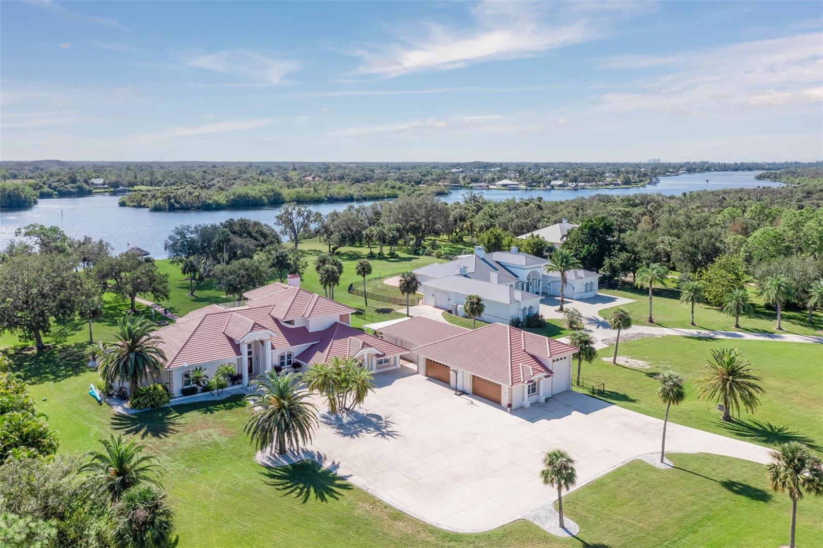 Nestled on nearly 4 acres of pristine riverfront property, this exceptional estate offers an unparalleled lifestyle of elegance, comfort and adventure. Set against the backdrop of sweeping river views, this luxurious home embodies the perfect balance of sophisticated design & outdoor recreation. With 190 feet of prime river frontage, you'll have direct access to the Gulf or Intercoastal & the opportunity to enjoy world-class boating & fishing right from your own backyard. As you enter this magnificent home, you’ll fall in love with the open floorplan, soaring ceilings, and abundance of natural light pouring thru oversized windows & doors that frame the breathtaking views. Italian marble floors flow seamlessly thru out the spacious living area enhancing the home's unique architecture & timeless appeal. This expansive living space blends comfort & functionality, creating a perfect space for casual living & entertainment. Relax in the family room with a cozy fireplace creating a warm & inviting atmosphere. The adjacent kitchen is a chef's dream, w/newer stainless appliances. white cabinetry, island, ample counter space & walk in pantry. The open flow continues into the large living area, ideal for casual gatherings or relaxing evenings. A raised sitting room completes the space, providing a quiet retreat to sit & read. With its thoughtful design, this great room is the true heart of the home, offering a harmonious balance of cozy spaces and open areas for stylish Florida living. Upstairs the spacious master suite awaits with the ultimate in comfort & privacy featuring wood burning fireplace, elegant bath suite w/shower & spa tub, walk-in closets & river views from the large patio. Downstairs you’ll find a versatile den/office plus two guest bedrooms w/luxurious bathroom complete with 2 sinks, shower & garden tub. Even a home theater designed for movie nights & fun, complete with projection TV, pool table, Murphy Bed & guest bedroom. Just steps outside discover your own private oasis...a resort-style pool w/spa, outdoor kitchen, full bath & 2 covered lanais ideal for alfresco dining year round. Enjoy cozy nights by the fire or picturesque sunsets waterside at the tiki bar. Boating enthusiasts, this is your dream come true w/well-appointed dock featuring huge 54K LB boat lift & 10K LB covered lift plus mooring space for larger vessels. Whether cruising the river or hosting a gathering, this home is designed to make the most of its stunning outdoor setting. Car enthusiasts will love the big 2,700+SF garage with A/C & plenty of room for large RV, boat, and 6+ cars...perfect for those who enjoy living life on the go. Set on a quiet street of luxury homes & zoned agricultural, offering flexibility for many uses & adding even more value to this already extraordinary estate. Horses/Farm Animals permitted & No HOA. Embrace the beauty of waterfront living at it’s best tucked away from it all, but just a short drive to Ft Myers & all SW Florida has to offer.
