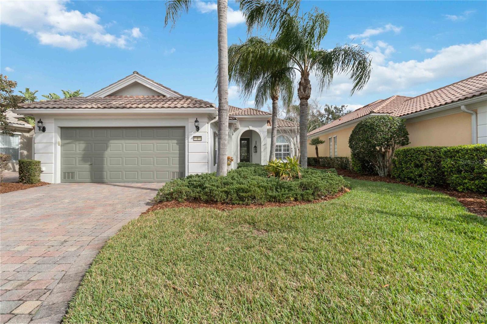 Welcome to 11819 Batello Lane, a meticulously maintained single-story home nestled in the gated community of VillageWalk at Lake Nona, This residence offers three bedrooms and two bathrooms, all thoughtfully designed to provide comfort and style. A Spacious Layout with a split floor plan ensures privacy. The primary suite features custom wainscoting, a large walk-in closet, and a well-appointed bathroom with dual vanities. The master has a beautiful view of the water. Recent modern upgrades: include crown molding throughout, fresh neutral paint, new carpeting in all bedrooms, and luxury vinyl plank flooring in the office. Your Gourmet Kitchen is equipped with brand-new stainless-steel appliances 2 refrigerators, glass-top slide-in stove with air fryer, dishwasher, and microwave. The kitchen is a culinary enthusiastic dream. A new Lennox AC system with an upgraded air scrubber and UV-enhanced air cleaner ensures a cool and healthy environment year-round. The home boasts a prime waterfront position, offering tranquility and privacy with no rear neighbors. Resort-Style Amenities: VillageWalk at Lake Nona provides a plethora of amenities, including a multi-use clubhouse, resort and lap pools, fitness center, deli, gas station, lighted walking paths, clay tennis courts, pickleball, and basketball courts. Convenient Location: Situated just 10 minutes from Orlando International Airport, Medical City, and the Brightline high-speed train to Miami, with easy access to major highways 417 and 528. World-famous attractions like Disney World, SeaWorld, Universal Studios, USTA, and Drive Shack are within a 30-minute drive. Experience the perfect blend of luxury, comfort, and convenience at 11819 Batello Lane a place you will be proud to call home.