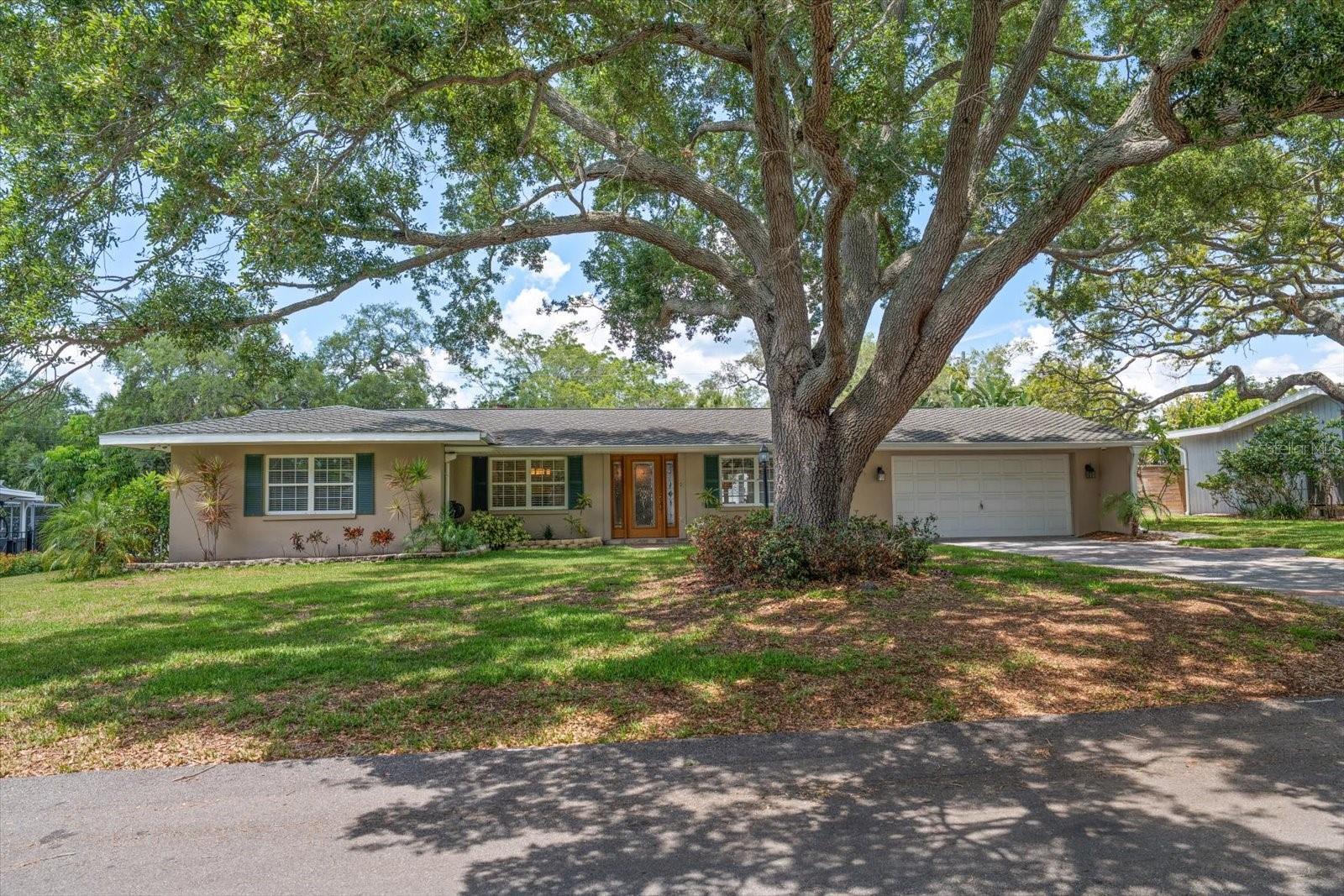 A rare gem in very desirable HARBOR BLUFFS! From the moment you enter, one will appreciate that this residence offers a perfect blend of spaciousness, an elegant layout, natural light and fine finishes. The floor plan flows smoothly, offering families with varied interest areas to spread out and appreciate this property that is designed for both daily living and impressive entertainment. A generous sized kitchen with large center island is the focal point of the house and will inspire any chef! Fully equipped, the kitchen offers stainless appliances, generous storage, and gleaming granite counters – imagine the culinary experiences!  Just steps away, a large family room with separate eat-in area provides ample space to gather or relax by the lovely fireplace. A three-way split bedroom floorplan, 2 with ensuite bathrooms, are all quite spacious, and allow for flexibility in use. Appreciate formal dining and living room areas-perfect for entertaining grandly. This home offers the best of all worlds; close to beaches yet not in an evacuation zone. Additionally, a lovely, inviting screened pool with an expansive side yard and deck offer privacy and endless possibilities for pets, play,  gardening or enjoying week-end bar-b-cue. The lot size is 100’ by 125’ and is completely fenced. Don’t miss this opportunity to live in a superb location, just a short drive from fabulous beaches, fine restaurants, shopping and major access roads to Tampa, St Pete and Clearwater Beach! Immediate opportunity too!