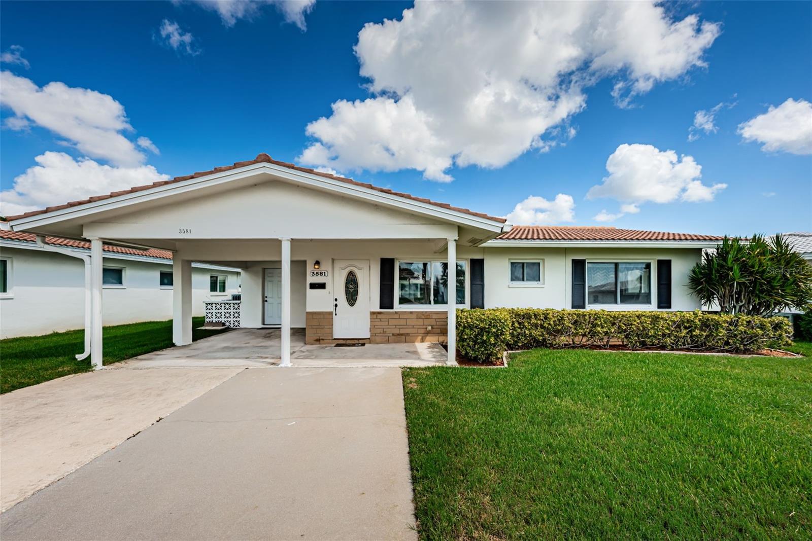 Welcome to carefree Florida living in one of Pinellas Park's most desirable 55+ maintenance-free communities! Nestled within a golf cart-friendly neighborhood known for its active lifestyle, beautifully maintained grounds, and outstanding amenities, this move-in-ready 2-bedroom, 2-bathroom home offers comfort, convenience, and peace of mind.

Boasting 1,328 square feet of well-designed living space, this freshly painted home features brand-new flooring in both bedrooms, updated baseboards, and ceiling fans throughout. The spacious interior is enhanced by double-pane hurricane-impact windows and a hurricane-rated rear door, providing both energy efficiency and added protection.

Storage is thoughtfully designed with custom closet systems, while the bright and inviting enclosed Florida room offers the perfect space to relax, entertain, or create a dedicated home office area without sacrificing your leisure space.

Major updates have already been completed, including a new roof in 2024 and a water heater installed in 2019. A French drain system was also added to help manage exterior water flow and enhance drainage around the property.

Whether you're looking to enjoy the community's vibrant social atmosphere, take a golf cart ride through the neighborhood, or simply relax in your own private retreat, this home is ready and waiting. Just bring your belongings and start enjoying the Florida lifestyle you've been dreaming about!