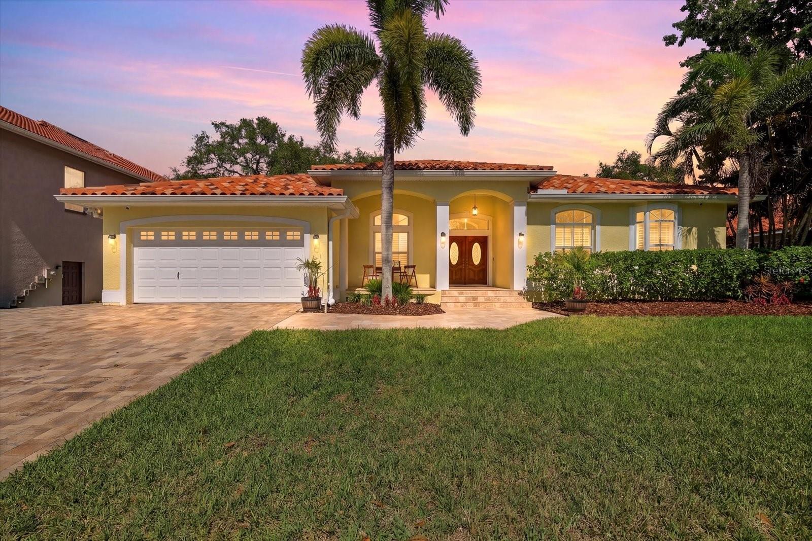 Beautifully updated 4-bedroom, 2-bath POOL HOME in the heart of Tarpon Springs featuring the ultimate backyard entertainer’s paradise! Offering peace of mind with Flood Zone X designation and NO FLOOD INSURANCE required!! From the moment you arrive, you’ll love the beautiful landscaping, paver driveway, paver front walkway and porch, double door entry, sidewalks throughout the community, and the added benefit of no HOA and No Flood Insurance Required.  Designed for both comfortable family living and entertaining, this home offers a screen-enclosed outdoor living area with heated saltwater PebbleTec Pool and Spa, travertine decking, built in OUTDOOR KITCHEN with gas grill, and fire pit — creating the perfect private outdoor retreat. Inside, you’ll find a spacious kitchen with breakfast nook, high ceilings, hardwood and tile flooring throughout, plantation shutters, stainless steel appliances, granite kitchen countertops, ample counter space and kitchen storage, indoor laundry room with wash sink, and sliding glass doors that seamlessly open to the outdoor living space. The oversized primary suite features 2 walk-in closets and a beautifully remodeled bathroom. Additional highlights include a 2021 A/C system, barrel tile roof 2014, Water Softner and 2-car garage.  This home is ideally located less than a mile from Fred Howard Park and 2 miles from Sunset Beach, with exceptional walkability and bikeability, plus close proximity to the Tarpon Springs Sponge Docks, charming downtown Tarpon Springs with local restaurants and breweries, the Pinellas Trail, shopping, dining, and highly rated schools..  Experience what the greater Tampa Bay area has to offer with nearby Gulf beaches, professional sports, theme parks, and attractions — this home offers the perfect blend of family living, entertainment, and the Florida lifestyle. *This home did not have any flooding during the 2024 storms.