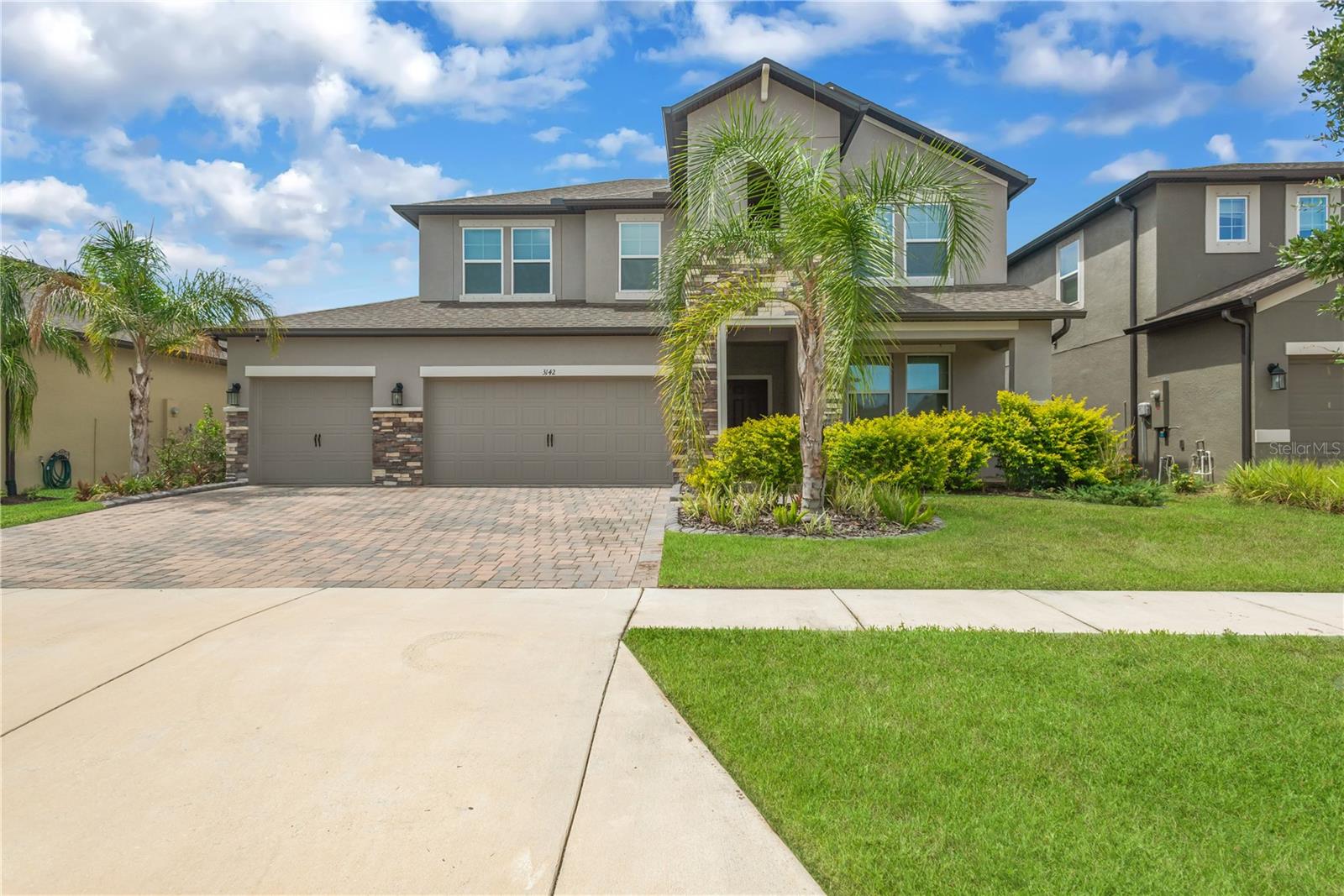 Experience modern Florida living at its finest in this stunning 4-bedroom, 3.5-bathroom residence nestled within the highly sought-after Berry Bay community of Wimauma. Designed with both elegance and functionality in mind, this spacious home offers an exceptional floor plan, stylish finishes, and access to resort-style amenities. Step inside to soaring cathedral and tray ceilings, abundant natural light, and an expansive open-concept layout that seamlessly connects the living, dining, and kitchen areas. One of the home's standout features is its incredible split floor plan, with the spacious primary suite conveniently located on the first floor for added privacy. Upstairs, a huge loft provides endless possibilities as a media room, game room, home office, playroom, or fitness space. The chef-inspired kitchen features solid wood cabinetry, elegant stone countertops, abundant prep space, and an open design overlooking the main living areas—perfect for entertaining or everyday living. The luxurious primary suite offers a tray ceiling, walk-in closet, and spa-like en-suite bath. Upstairs, one secondary bedroom includes its own private en-suite for guests, or extended family, while two additional bedrooms share a well-appointed guest bathroom. Additional highlights include Smart Home technology, energy-efficient features, ceiling fans throughout, built-in hurricane shutters, and a spacious three-car garage offering plenty of room for vehicles and storage. Enjoy Florida's year-round sunshine with outdoor space perfect for relaxing or entertaining. Berry Bay residents enjoy a resort-style pool, clubhouse, playground, park, and beautifully maintained common areas. With a low annual HOA fee of just $90 as well as a separate CDD fee, the community offers outstanding amenities while preserving its long-term appeal. Conveniently located near shopping, dining, medical facilities, golf courses, I-75, and US-301, Wimauma continues to grow in popularity thanks to its peaceful setting and easy access to Apollo Beach, Little Harbor Marina, downtown Tampa, Sarasota, and the Gulf Coast's beautiful beaches!