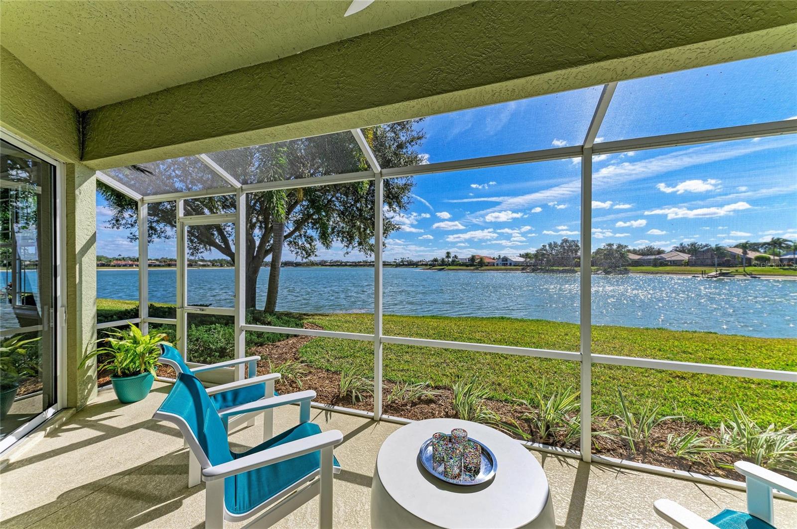 MOTIVATED SELLER! BRING OFFERS! Welcome to the peace and quiet of your extraordinary WATERFRONT residence in The Moorings at Edgewater in Lakewood Ranch where nature meets elegance and convenience. With over $180,000 in recent renovations, this stunning, spacious and rarely available THREE BEDROOM, 2 1/2 bathroom modern oasis with attached 2 car garage is move-in ready and lives like a private home. This sought-after unit is ideally positioned on the southern side of the community along Lake Uihlein, offering shimmering water views through expansive sliding glass doors, perfect for bird watching, and enjoying breathtaking sunrise and sunset backdrops. The interior has been fully transformed with luxury vinyl plank flooring in the main living areas, freshly painted, new recessed lighting, new modern LED chandeliers, 5 new Minka Aire fans, a chef-inspired bright kitchen featuring custom cabinetry, quartz countertops, imported tile backsplash, and a full LG stainless steel appliance suite with convection & air fryer options.. The primary suite has sliding doors to the lanai featuring water views, new plush carpeting, dual custom closets and a new spa-like bathroom with imported tile, custom vanities with quartz counters, comfort-height fixtures, and a glass-enclosed walk-in shower with bench and niche.  Additional highlights include abundant storage, custom laundry cabinetry with quartz countertop and new large capacity LG washer and dryer, custom closets, newly screened lanai with LED lighting and new ceiling fan, and two guest rooms, one is an ensuite, and the other has an adjacent half bath and sliding glass doors to a delightful courtyard for an alfresco retreat. A large garage with new 50-gallon water heater, a tile roof and air conditioning unit installed less than 5 years ago complete this maintenance-free home. The lifestyle at The Moorings is just as impressive as the residence itself. Ideally located just one block from Main Street, you’re steps away from exciting restaurants, boutique shopping, cinema, and mini golf—placing everyday convenience and entertainment right at your doorstep. Residents enjoy one of the lowest condo fees in the area and a secure, gated, private-road community anchored by a well-appointed clubhouse featuring a full kitchen, bar, library, billiards, fireplace, fully equipped fitness center, and event space for social gatherings. Outdoor amenities include a resort-style heated pool and spa with a Tiki bar, and BBQ grilling area. Nature lovers will appreciate direct access to Lake Uihlein for kayaking, canoeing, and paddle boarding, along with a private island complete with boardwalk, gazebo, kayak storage, fishing pier, docks and an optional boat club—creating a true resort-inspired, waterfront lifestyle in the heart of Lakewood Ranch. The community has an on-site manager to handle any of your condo needs. This truly is a lock and leave maintenance free home. Don’t miss this rare opportunity and schedule a showing today.