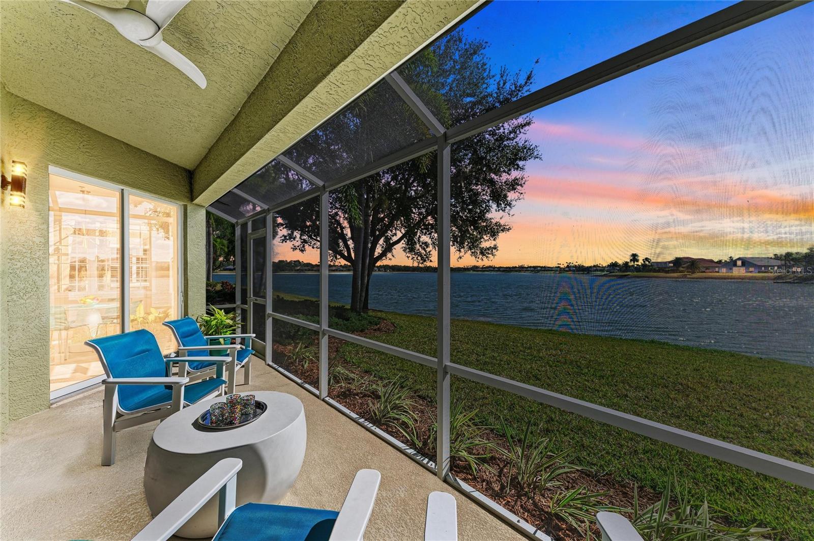 MOTIVATED SELLER! BRING OFFERS! Welcome to the peace and quiet of your extraordinary WATERFRONT residence in The Moorings at Edgewater in Lakewood Ranch where nature meets elegance and convenience. With over $180,000 in recent renovations, this stunning, spacious and rarely available THREE BEDROOM, 2 1/2 bathroom modern oasis with attached 2 car garage is move-in ready and lives like a private home. This sought-after unit is ideally positioned on the southern side of the community along Lake Uihlein, offering shimmering water views through expansive sliding glass doors, perfect for bird watching, and enjoying breathtaking sunrise and sunset backdrops. The interior has been fully transformed with luxury vinyl plank flooring in the main living areas, freshly painted, new recessed lighting, new modern LED chandeliers, 5 new Minka Aire fans, a chef-inspired bright kitchen featuring custom cabinetry, quartz countertops, imported tile backsplash, and a full LG stainless steel appliance suite with convection & air fryer options.. The primary suite has sliding doors to the lanai featuring water views, new plush carpeting, dual custom closets and a new spa-like bathroom with imported tile, custom vanities with quartz counters, comfort-height fixtures, and a glass-enclosed walk-in shower with bench and niche.  Additional highlights include abundant storage, custom laundry cabinetry with quartz countertop and new large capacity LG washer and dryer, custom closets, newly screened lanai with LED lighting and new ceiling fan, and two guest rooms, one is an ensuite, and the other has an adjacent half bath and sliding glass doors to a delightful courtyard for an alfresco retreat. A large garage with new 50-gallon water heater, a tile roof and air conditioning unit installed less than 5 years ago complete this maintenance-free home. The lifestyle at The Moorings is just as impressive as the residence itself. Ideally located just one block from Main Street, you’re steps away from exciting restaurants, boutique shopping, cinema, and mini golf—placing everyday convenience and entertainment right at your doorstep. Residents enjoy one of the lowest condo fees in the area and a secure, gated, private-road community anchored by a well-appointed clubhouse featuring a full kitchen, bar, library, billiards, fireplace, fully equipped fitness center, and event space for social gatherings. Outdoor amenities include a resort-style heated pool and spa with a Tiki bar, and BBQ grilling area. Nature lovers will appreciate direct access to Lake Uihlein for kayaking, canoeing, and paddle boarding, along with a private island complete with boardwalk, gazebo, kayak storage, fishing pier, docks and an optional boat club—creating a true resort-inspired, waterfront lifestyle in the heart of Lakewood Ranch. The community has an on-site manager to handle any of your condo needs. This truly is a lock and leave maintenance free home. Don’t miss this rare opportunity and schedule a showing today.