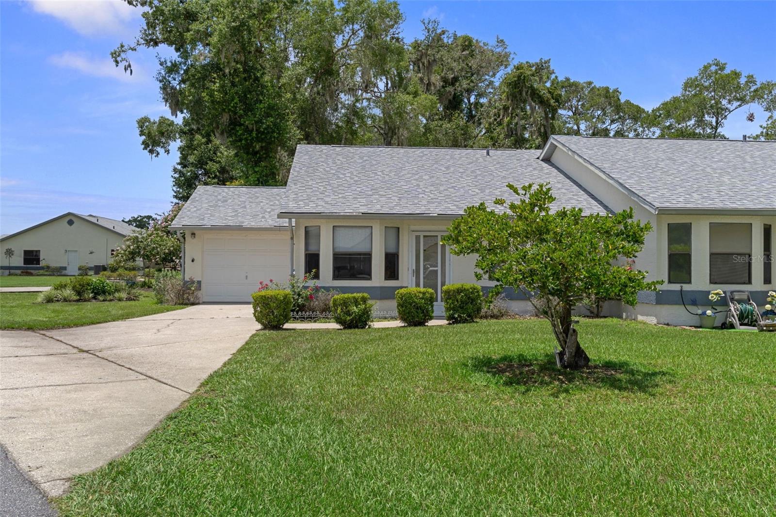 If you're looking for low-maintenance living, this 2-bedroom, 2-bath villa is worth a look. Located just a short walk from the community clubhouse and pool, this home has been well cared for and comes completely furnished, including the furniture, dishes and linens—just bring your suitcase.

Inside you'll find a separate dining room, a breakfast nook off the kitchen, and a comfortable living room with sliding glass doors leading to the screened lanai. Just outside the lanai is an additional open patio, giving you both covered and uncovered outdoor space. The backyard has a nice mix of shade and sunshine, so you can enjoy it throughout the day.

Major updates have already been taken care of with a roof replaced in 2021, HVAC in 2023, and a new water heater. The washer and dryer stay, and the one-car garage includes a rear access door for added convenience.

The HOA takes care of the lawn, the exterior of the home, and the roof, making it easy to spend more time enjoying your home and less time maintaining it. 

The location is another standout feature. Whispering Pines Park is right next door, offering walking trails, tennis and pickleball courts, playgrounds, and plenty of green space to enjoy. You're also just about a mile from Historic Downtown Inverness, where you'll find locally owned restaurants, shops, festivals, the Valerie Theatre, the Depot District, and access to the Withlacoochee State Trail. Whether you're looking for outdoor recreation or a night out downtown, it's all just minutes from your front door.
