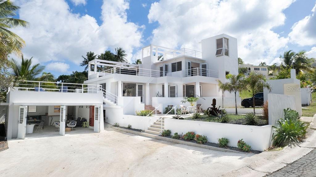 Casa Solsticio is a gem situated just steps away from La Chata beach in Bravos de Boston.  Inside, the ocean’s presence and refreshing cross breeze can be felt from every corner.  Each space masterfully interconnects with an outdoor balcony or terrace, doubling the size of the living quarters and allowing natural light to flood the interiors.

With it’s clean geometric lines and saltillo tiles, the principal structure’s architecture has a western mediterranean look, similar to that of the Bealearic Islands. The first level has an ample commercial style kitchen, dining room, and living room with a street-side porch, spacious enough for a outdoor seating and lounging.  The principal bedroom has an ensuite bathroom with an outdoor shower and is adjoined to a private solarium terrace that has a solar powered lap pool shaded from the afternoon sun.

On the second level is a full private loft with an open concept living room, bedroom, private bathroom, and a generous walk-in closet.  The loft has both a balcony and a spacious terrace with a full outdoor kitchen and dining area.  Above, a rooftop promenade has amazing views of the turquoise waters.  Electricity connections are also available to light up the space and add music for rooftop cocktail parties.

Adjacent to the principal house is a separate studio apartment with a full kitchen, bathroom dining, living, and bedroom spaces.  The studio also has it’s own rooftop terrace so guests can enjoy soaking up the rays or the starry nights.

Located in a quiet residential street that is just a five minute drive to the ferry and downtown.  The home is tastefully furnished, is equipped with AC in all the spaces, and has a laundry area.  With two carports that have space for up to five cars, this is the perfect home for living and hosting.