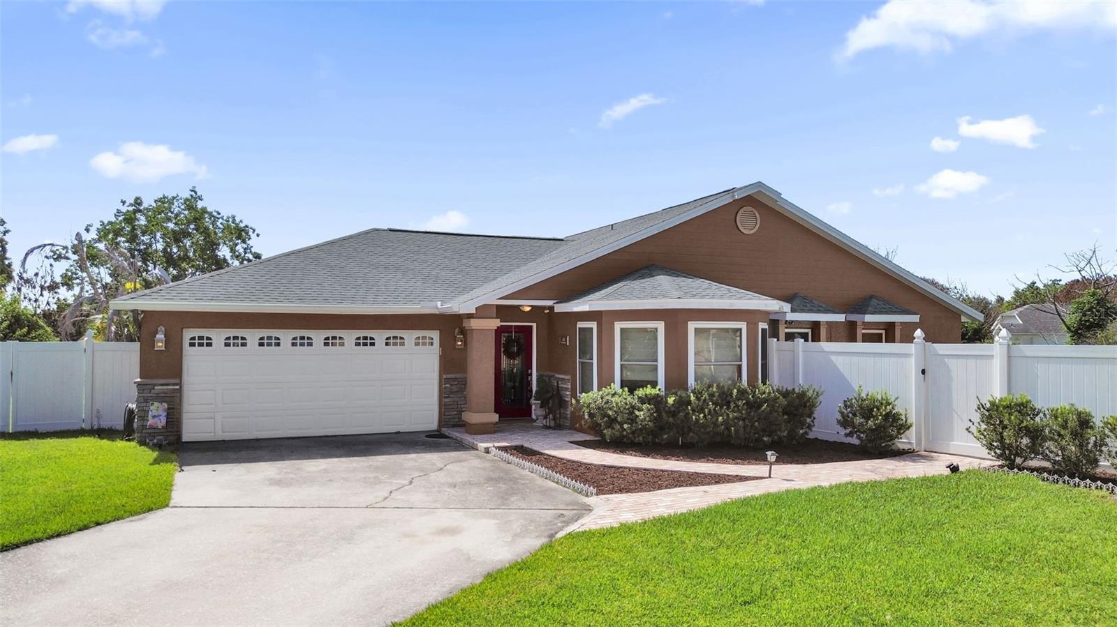 A screened in-ground pool, covered lanai, and generous fenced backyard set the stage for relaxed Florida living at this move-in ready single-story Cypress Lakes home, perfectly positioned on a 0.27-acre lot with no HOA or CDD. Inside, 1,472 square feet offers three bedrooms and two full baths, with tile flooring flowing through the foyer, living room, dining area, kitchen, and breakfast nook to create a cohesive and easy-to-maintain living space. The main living area feels bright and welcoming, with multiple windows and sliding glass doors that frame views of the pool and invite natural light while seamlessly blending indoor comfort with outdoor enjoyment. The kitchen is both functional and inviting, featuring dark wood cabinetry, granite countertops, black appliances, a breakfast bar for casual conversations, and a sunny nook that’s perfect for morning coffee or relaxed meals. Three carpeted bedrooms provide comfortable retreats for rest, guests, or a home office, while the two bathrooms include a tub-and-shower combination in one and a distinctive glass-block shower in the other. Step outside to enjoy the screened pool and paved deck, ideal for weekend gatherings, afternoon swims, or simply unwinding under the Florida sun, while the covered lanai offers a shaded spot for dining or quiet evenings. Beyond the enclosure, the fenced backyard provides even more space for pets, play, or gardening. Convenient access to Osceola Parkway and Florida’s Turnpike adds everyday ease to this inviting Cypress Lakes property, which blends a practical one-level layout with generous outdoor living and the freedom of ownership without association fees.