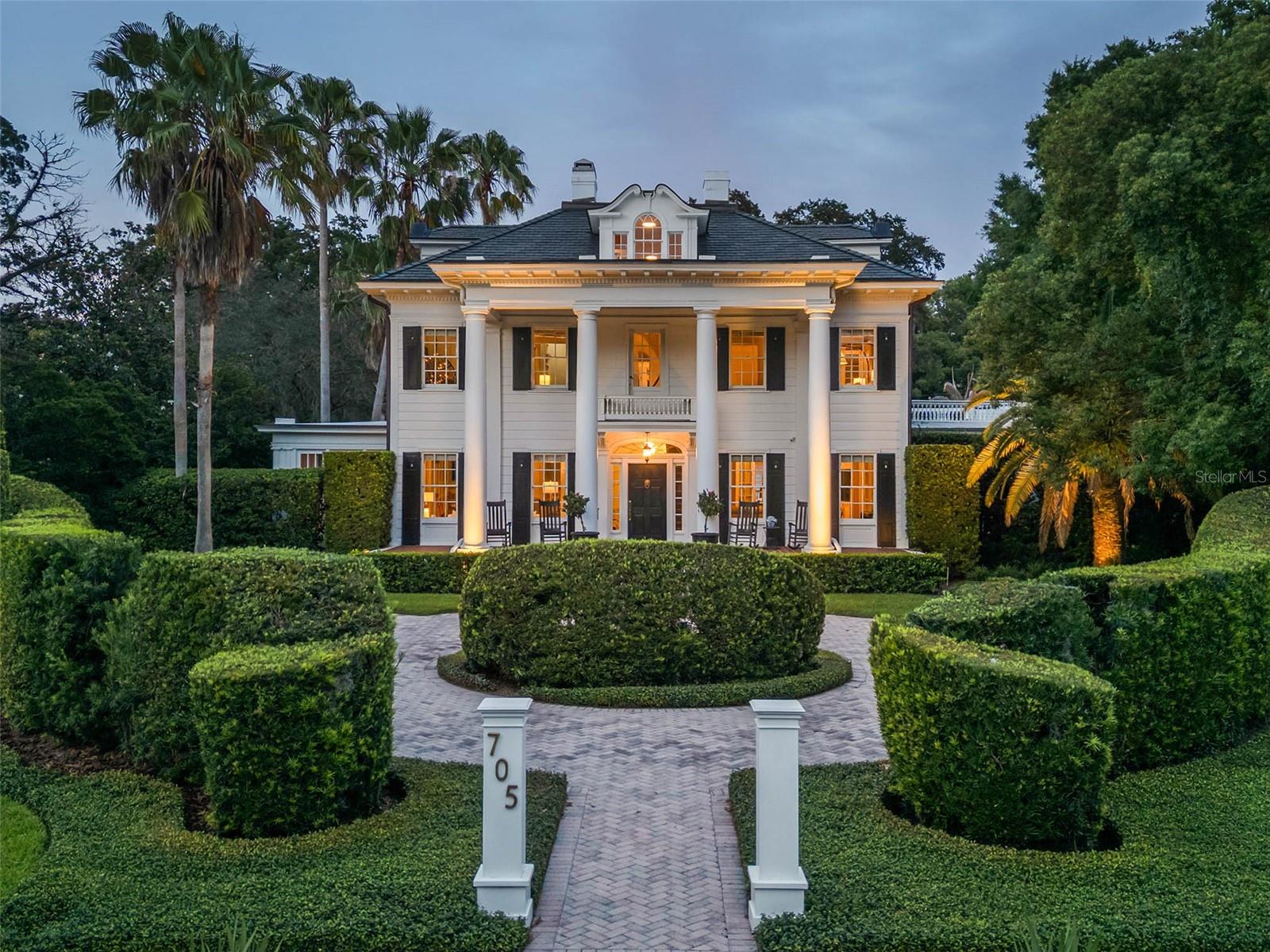One of Orlando’s signature homes in the Cherokee Historic District, this extraordinary estate exudes elegance and timeless grandeur, offering a resort-style pool, private guest house and expansive grounds in one of downtown’s most coveted neighborhoods.

Set on an oversized lot (.56 acres), this stately three-story, 18-room residence offers an impressive blend of scale, craftsmanship and thoughtful updates. A dramatic oval, handcrafted three-story staircase creates a striking first impression in the grand black-and-white marble foyer, flanked by formal living and family rooms designed for both elegant entertaining and comfortable living. The living room extends into a light-filled sunroom, ideal as a private office or studio, while the family room opens to a screened porch with slate flooring, seamlessly connecting indoor and outdoor spaces.

The chef’s kitchen is both functional and refined, featuring an oversized island, Wolf convection gas range, Sub-Zero refrigeration with additional drawer units, custom cabinetry, and purified drinking water. Overlooking the beautifully refinished pool and outdoor entertaining areas, the kitchen flows effortlessly into a well-appointed summer kitchen, perfect for hosting.

Interior details reflect exceptional character and craftsmanship, including wood flooring throughout most of the home, decorative ceiling elements, picture rails, brass antique light switches, and a wood-burning fireplace. The spacious primary suite features soaring ceilings and a large bath with an oversized shower and distinctive metal sinks. A secondary staircase and basement level-with updated laundry, dual washers, drying area, and laundry chute-add both charm and functionality.

Extensive recent improvements totalling over $200,000 enhance both beauty and peace of mind, including a new slate roof (2024), copper gutters and soffits, updated flat roofs, new insulation, upgraded electrical and multiple HVAC systems, along with a tankless water heater for the main house and separate for the guest house.

The outdoor setting is equally impressive, with mature landscaping, a motor court, two-car garage, and a private one-bedroom guest house complete with full kitchen and bath. Additional features include Tesla charging capability and a prepaid termite bond.

Ideally located just minutes from downtown Orlando, within walking distance Restaurants, Farmers market, Arts festivals, Dr. Phillips Center for the Performing Arts and less than a mile from Orlando Health ORMC, the home offers both convenience and prestige.

Originally built for Dr. and Mrs. John S. McEwan, among early Orlando’s most prominent families and featured on the cover of Orlando Magazine in 1923, this residence is a rare legacy property, thoughtfully maintained and updated to meet the standards of today’s most discerning buyer while preserving its rich architectural heritage. Furnishings may convey with acceptable contract. Home has been pre-inspected.