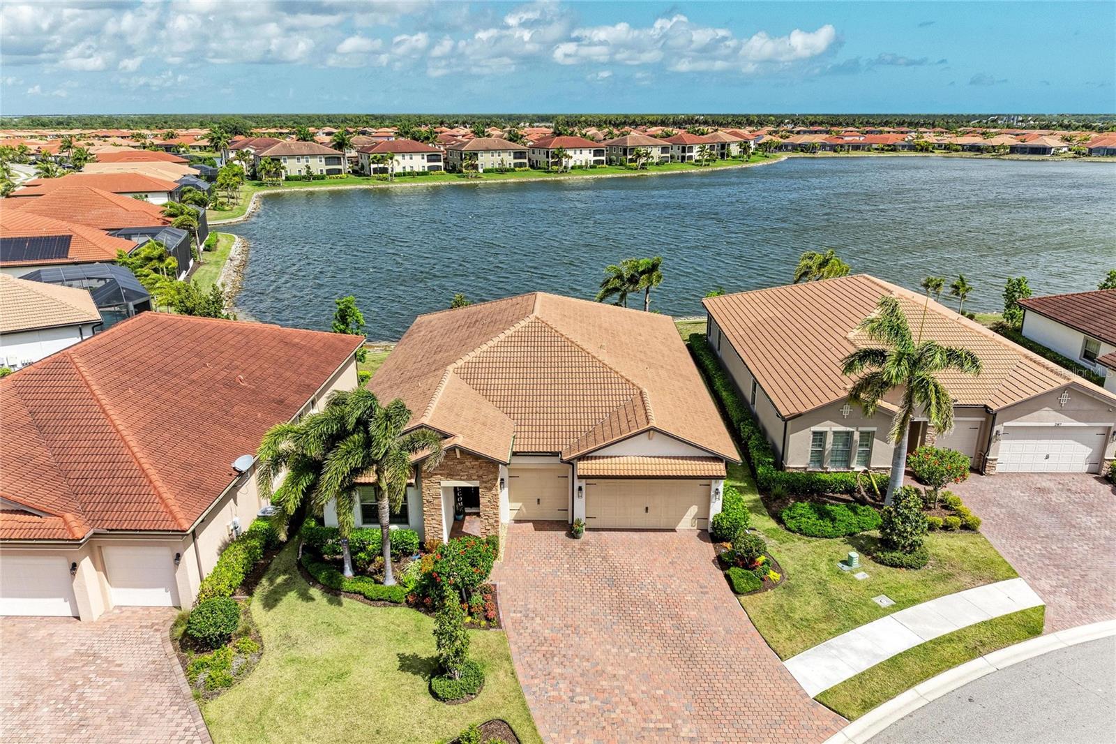 Wonderful opportunity to make this meticulously maintained 2,352SF Abbey floor plan your own! This stunning residence offers exceptional curb appeal and includes 3 spacious bedrooms, a den, 2.5 bathrooms, a generous 3-car garage, all situated on an incredible lakefront lot that offers plenty of space for your dream pool (pool proposal is attached to MLS). This property truly has it all! As you step inside, you're immediately greeted by breathtaking views of the serene 33-acre lake and a wide open floor plan. The inviting modern kitchen, equipped with high-quality finishes, will spark your culinary passion. Its expansive layout, complete with a large island that flows seamlessly into the dining area and an incredibly spacious great room, creates a bright and contemporary living space. The main living area and den showcase beautiful wood-look large plank tile floors, soaring ceilings, 8-foot interior doors, and exquisite crown molding, creating a warm and welcoming atmosphere. In the kitchen, the stylish white cabinets, chic backsplash, quartz countertops, and stainless steel appliances combine to create an elegant and polished aesthetic. Picture yourself enjoying delightful views of the shimmering lake from your kitchen island while you whip up your favorite recipes! Retreat to the primary suite at the back of the home, where you’ll find two walk-in closets and a luxurious en-suite bathroom featuring dual sinks and a large walk-in shower, offering a private sanctuary for relaxation. The two additional bedrooms, thoughtfully located at the front of the house, share a Jack and Jill bathroom equipped with dual sinks and a separate tub/shower combination­perfect for accommodating family or guests! The thoughtfully placed den overlooks the spacious covered lanai and the lake, providing an inspiring work environment. Speaking of the outdoors, the expansive covered lanai is pre-plumbed for an outdoor kitchen, making it an ideal spot for enjoying al fresco dinners or entertaining friends against the stunning backdrop of the sparkling lake. Toscana Isles is a premier gated community that embraces a resort-style lifestyle perfect for those eager to engage in an active, fulfilling life. Imagine kayaking, canoeing, or fishing on over 200 acres of beautifully interconnected lakes! The grand 8,000-square-foot clubhouse is a vibrant social hub, featuring a fitness center, ballroom, and a billiards room with a big-screen TV­a place where unforgettable memories are made! Location? You’ve got it! A quick 10-minute drive takes you to gorgeous Suncoast beaches, the scenic Legacy Trail, and a fantastic array of shopping, dining, and cultural experiences in Venice and Sarasota. Plus, with the new Sarasota Memorial Hospital campus nearby, all your needs are comfortably within reach. This exceptional opportunity is not one to miss! Reach out today for your private showing­. You won’t regret it!
