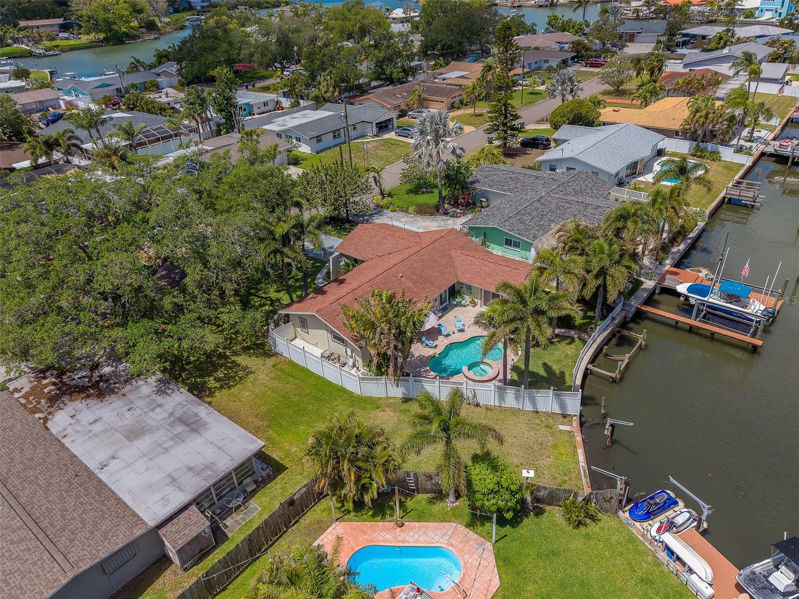 Huge Price Adjustment! 
Welcome to your slice of Florida paradise—where Contemporary Mediterranean style meets effortless coastal living!

This beautifully inviting 3-bedroom, 2-bath waterfront, pool home offers a spacious open-concept design perfect for both relaxing and entertaining. The heart of the home is a stunning granite kitchen featuring a huge wrap-around peninsula offering bar seating and gorgeous solid wood cabinetry, seamlessly flowing into a bright and airy great room highlighted by a dramatic wall of windows. Natural light pours in, showcasing serene views of your private, lushly landscaped backyard oasis.

Inside, the home boasts gleaming just-refinished natural travertine floors throughout the main living areas and brand-new luxury vinyl flooring in all bedrooms. The thoughtfully designed split-bedroom floor plan provides comfort and privacy, while both bathrooms have been tastefully updated with granite finishes. The spacious primary suite features a beautifully tiled shower for a spa-like experience.

Step outside to enjoy your own resort-style waterfront retreat complete with a sparkling pool, soothing spa, and elegant landscape lighting—ideal for evening gatherings or peaceful nights under the stars. The fully fenced yard ensures total privacy, while a charming courtyard leads you directly to the waterfront. Watch dolphins, manatee, fish and countless waterfowl frolic right from your seawall or while luxuriating in your pool.

Boaters will love the 50 feet of seawall making for easy, navigable canal access leading directly to the Intracoastal Waterway and the Gulf, with ample space ready for a boat lift or new dock.

Additional highlights include, New water heater (2026) and Fresh interior and exterior paint
This home is in Move-in ready condition

Enjoy unbeatable convenience just minutes from local hospitals, shopping, dining, vibrant nightlife, and the pristine, sugar-white sands of Indian Rocks Beach—accessible by car, bike, or even by boat!

For peace of mind, remediation from minimal flooding related to Hurricane Helene (09/26/2024) has been fully completed, professionally inspected, and approved, with documentation available. Total remediation costs were approximately $10,000.

This is more than a home—it’s a lifestyle. Don’t miss your opportunity to own this waterfront gem—schedule your private showing today!

Per the sellers instructions; only COMPLETE written offers using FAR/BAR contract forms and including all appropriate addenda and recent Pre-Approval Letters or recent Proof of Funds documentation, will be considered by the seller.