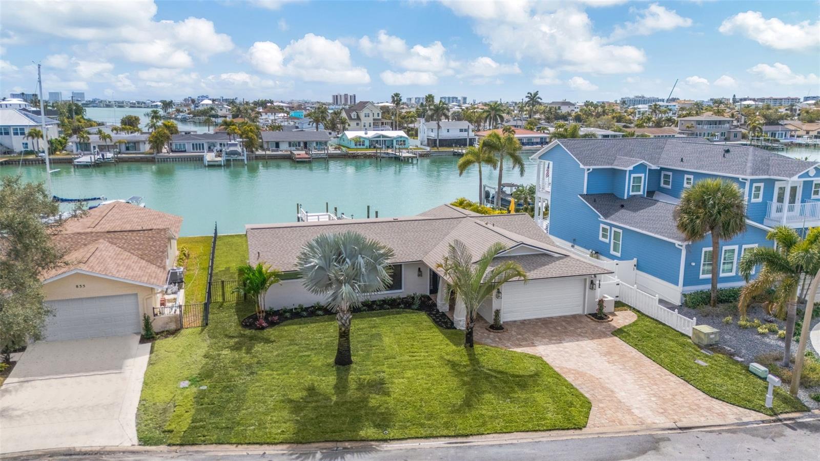 Lease/Purchase Options available. Beach Home Completely reimagined and renovated by Parks Property Builders, 
This stunning waterfront residence blends timeless mid-century modern design with luxury. Tucked away in a quiet cul-de-sac in the highly sought-after Capri's Isles neighborhood of Treasure Island, beautiful three-bedroom, two-bath home offers both open style and serenity. Enjoy true Florida living with your boat just steps away on your private dock, perfectly positioned beside the sparkling large pool overlooking the wide open water views. Inside, every detail has been thoughtfully updated from bottom to top, creating a turn-key ready home that feels brand new. The spacious owner's suite features dual walk-in closets and a spa-inspired en suite bath complete with double shower, double sinks, and vanities. and double closets. Throughout the home, elegant ceramic tile adds warmth and continuity. Expansive glass sliders line the rear of the home, opening it up completely to the outdoors, filling the space with natural light and showcasing breathtaking water views. Designed for both everyday living and entertaining, the Chef's Kitchen boasts an oversized center island and top-of-the-line, professionally grade appliances. Step outside to a generous travertine patio ideal for hosting or relaxing poolside in your private waterfront oasis. Additional upgrades include: Brand new landscaping, New air conditioners, New pool and new pool equipment, Roof  water heater. Ensuring peace of mind for years to come. This beautifully finished coastal retreat is move-in ready and truly exceptional.