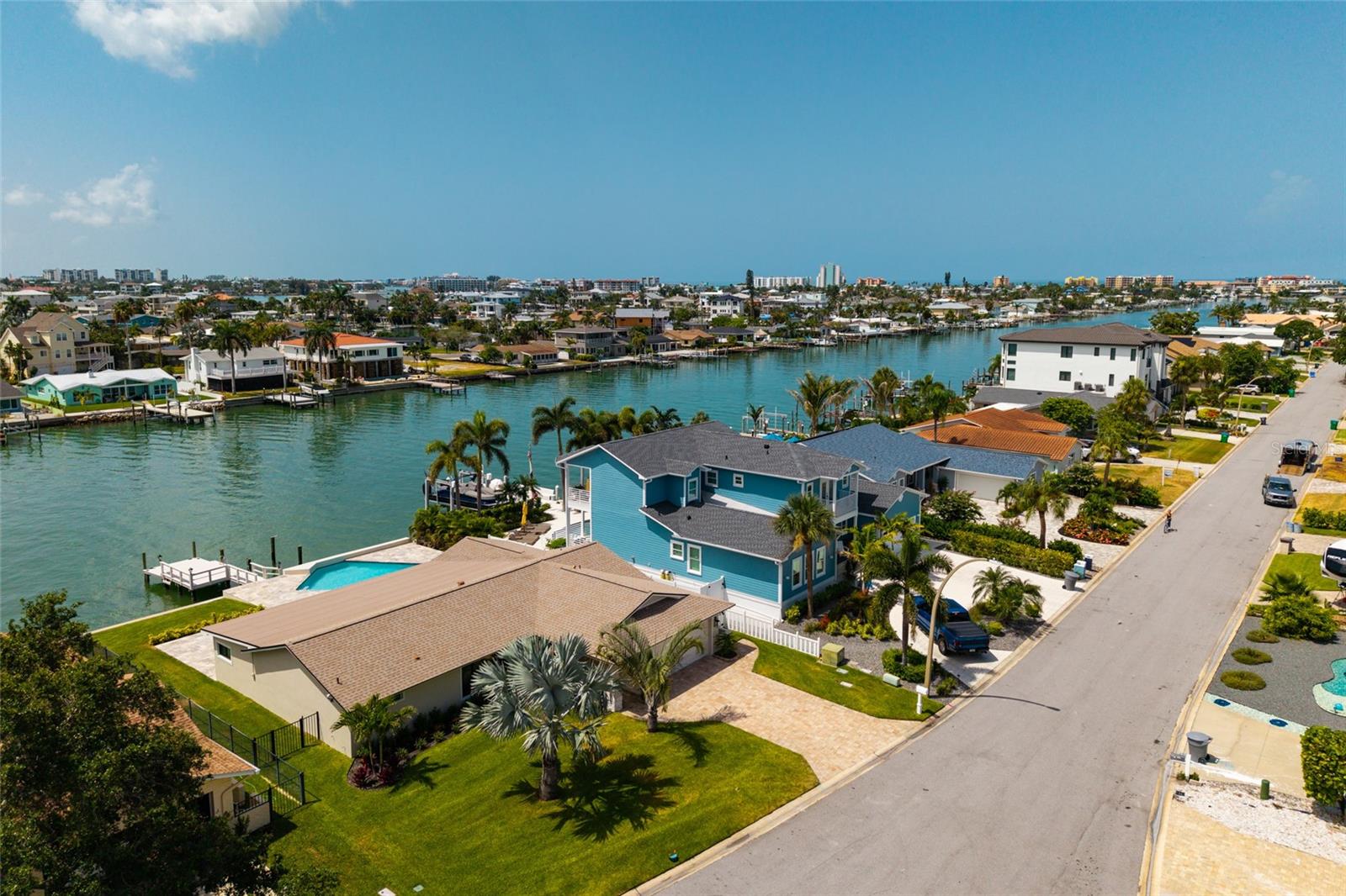 Lease/Purchase Options available. Beach Home Completely reimagined and renovated by Parks Property Builders, 
This stunning waterfront residence blends timeless mid-century modern design with luxury. Tucked away in a quiet cul-de-sac in the highly sought-after Capri's Isles neighborhood of Treasure Island, beautiful three-bedroom, two-bath home offers both open style and serenity. Enjoy true Florida living with your boat just steps away on your private dock, perfectly positioned beside the sparkling large pool overlooking the wide open water views. Inside, every detail has been thoughtfully updated from bottom to top, creating a turn-key ready home that feels brand new. The spacious owner's suite features dual walk-in closets and a spa-inspired en suite bath complete with double shower, double sinks, and vanities. and double closets. Throughout the home, elegant ceramic tile adds warmth and continuity. Expansive glass sliders line the rear of the home, opening it up completely to the outdoors, filling the space with natural light and showcasing breathtaking water views. Designed for both everyday living and entertaining, the Chef's Kitchen boasts an oversized center island and top-of-the-line, professionally grade appliances. Step outside to a generous travertine patio ideal for hosting or relaxing poolside in your private waterfront oasis. Additional upgrades include: Brand new landscaping, New air conditioners, New pool and new pool equipment, Roof  water heater. Ensuring peace of mind for years to come. This beautifully finished coastal retreat is move-in ready and truly exceptional.