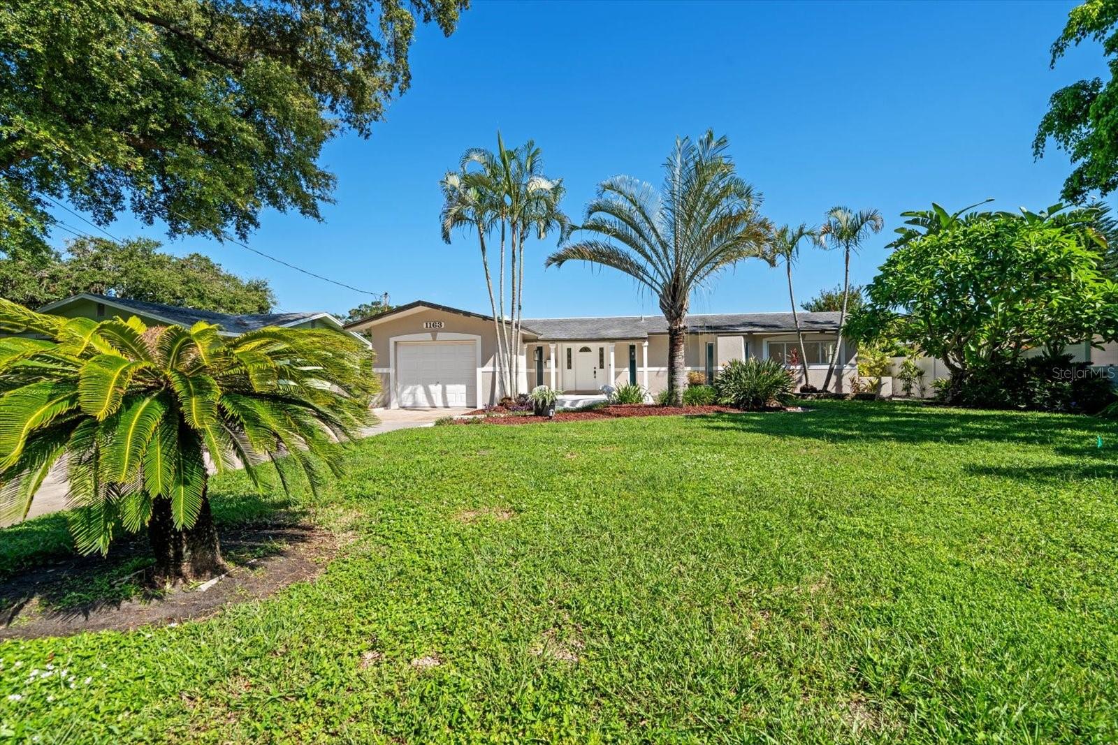 Welcome to your waterfront retreat in the highly desirable Coronado Lake neighborhood of South St. Petersburg. This beautifully renovated lakefront residence combines timeless charm with modern upgrades, offering exceptional curb appeal and breathtaking water views from nearly every room.  
Step inside to discover refinished terrazzo floors and an open-concept floor plan designed for comfortable living and effortless entertaining. The spacious kitchen is the heart of the home, featuring solid wood cabinetry, granite countertops, stainless steel appliances, a gas range, microwave, dishwasher, and refrigerator—all seamlessly flowing into the living and family room areas.
The inviting family room showcases a wood-burning fireplace with a natural gas connection and opens directly to a large refinished patio overlooking the tranquil lake, creating the perfect setting for morning coffee, evening sunsets, or gatherings with family and friends.
The private primary suite offers a walk-in closet and a beautifully updated spa-inspired bathroom. A second fully renovated bathroom is equally impressive, featuring quality finishes and thoughtful design.
Additional upgrades include new baseboards, trim, interior doors and hardware, lighting fixtures, ceiling fans, insulated vinyl windows, and a security system. Major systems have been well maintained, including a new electric water heater (May 2026) and A/C system (8 years old).
Outside, enjoy a lake-fed irrigation system, a pristine freshly painted one-car garage, and an incredible detached shed complete with electricity and a covered lounging area—perfect for a workshop, hobby space, or relaxing lakeside retreat.
With quality renovations throughout, stunning waterfront views, and a peaceful setting in one of South St. Petersburg's most sought-after neighborhoods, this move-in-ready home is a rare opportunity you won't want to miss.  Some photos have been virtually staged.