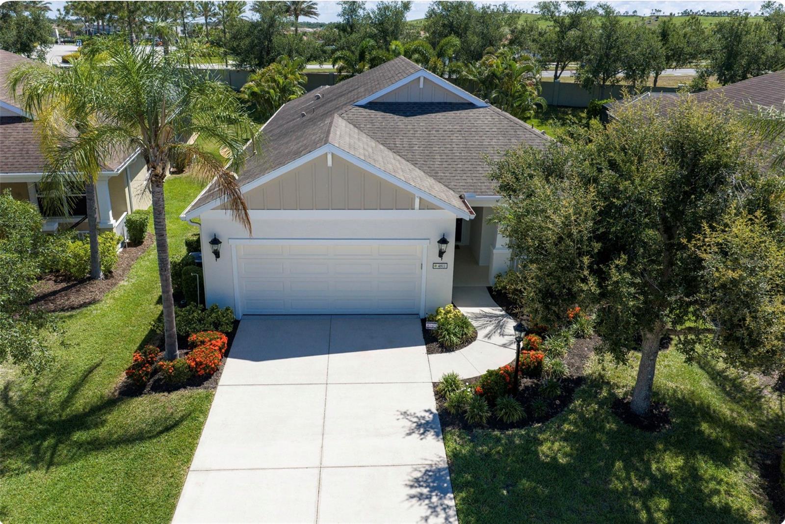 Looking for a super location, trying to get into Woodbrook, a comfortable gated community, close to everything?  Well, here is your opportunity.  This one owner pool home has it all and has been meticulously maintained since being built.  This Starlight model, NEAL home, has 3Br with a den that could easily be a fourth bedroom and 2.5 baths with all of the features you are searching for.   Shows like a model and has so many features you can’t list them all here but come and experience this one, you won’t regret it.  Some of the features are as follows: Plantation shutters, recessed lighting and ceiling fans throughout the house.   Entering the home, the Foyer-Gallery area features porcelain tile which extends into the guest bath, laundry room, and second full guest bathroom.  Coming into the Kitchen and open LR and Dining room area you see Granite countertops, A walk-in pantry area, 36” upper cabinets, tiled backsplash, an island and sit able bar area which conveniently doubles as a workspace, SS GE profile appliance package and crown molding.  For our cooks, there is GAS.  For those eco-minded amongst us, there is gas for the grill, stove, dryer, hot water heater, pool heater, and the recently installed whole house Generac Guardian 18kW Generator which kicks on to keep you comfortable during any electrical interruptions due to those pesky wind events we get from time to time. The flooring is a waterproof Rigid Core Luxury Vinyl laminate in the kitchen, dining room and Great Room, with the Great room featuring trey ceilings with a tasteful inset of grass cloth and crown molding.  The flooring in the rest of the house is a combination of porcelain tile, wood laminate and carpet.  The Office/Den/potential fourth bedroom, is a larger room and has a set of French doors that accents its entry and Crown Moulding as well.  There is a surround sound speaker system built into the ceiling, which is also associated with the owned security system, and allows music to play in the Great room and Lanai area.  Moving into the Master Bedroom you will see trey ceilings, crown molding, wall to wall carpeting, two walk-in closets, porcelain tile in the bathroom, a Roman shower, and Corian countertops with double sinks so you don’t have to share in the morning.  Did I say plantation shutters all the way through, I think I did.  As you move outside, the lanai was extended during the heated pool/spa construction so you will have more space to relax and enjoy this beautiful home.  The owner even tied the gutter and downspout system into an underground French drain system that was added to help direct water to the appropriate places for great drainage.  Simply thought of everything.  Come and see this one, it shouldn’t last long.