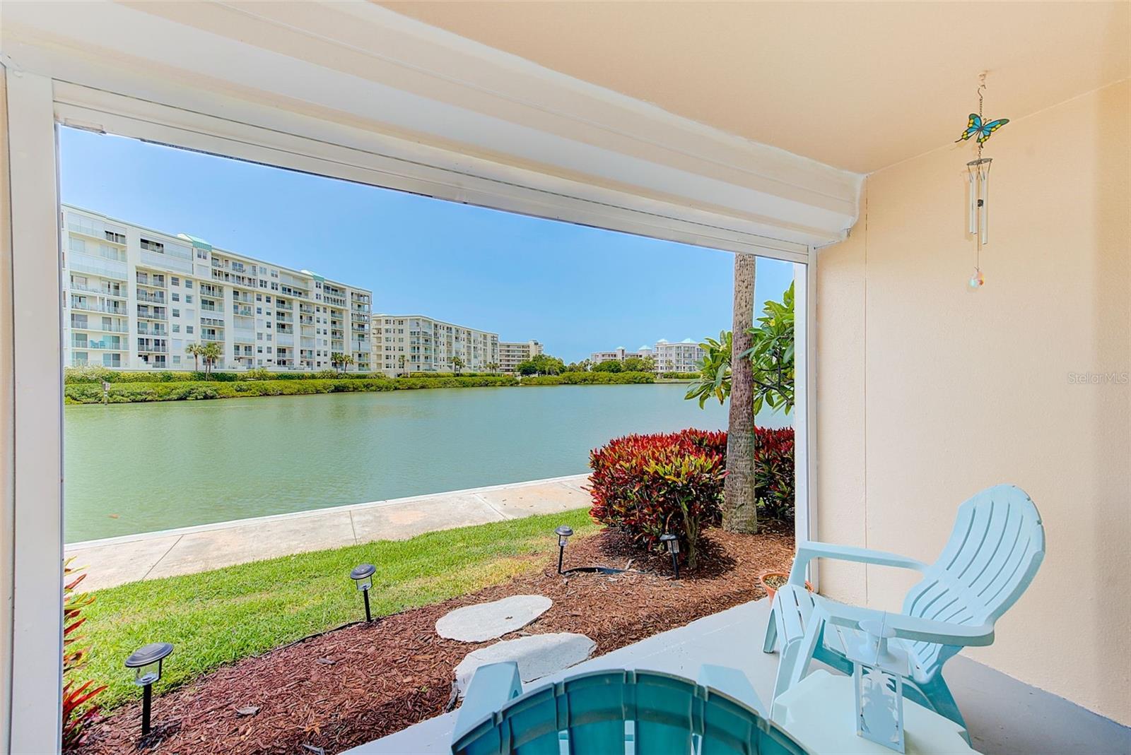 I’M SIMPLY GORGEOUS!!! Welcome to your dream waterfront condo in the Enterprise building at the Bay Island 55+ Condo Community, where breathtaking sunset views and an unbeatable coastal lifestyle take center stage. This stunning first-floor, end unit offers a beautifully reimagined open-concept design and has been thoughtfully restored and refreshed, now featuring updated systems including new electrical and HVAC for added peace of mind.
This residence has a long history of being high and dry, with the recent storm event being a rare and unprecedented occurrence. The home has since been carefully brought back to its prior condition with a few tasteful updates, allowing you to enjoy all the beauty of this exceptional property without compromise.
From the moment you step inside, you’re drawn to the expansive water views and the seamless flow of luxury vinyl plank flooring throughout. The kitchen is both stylish and functional, showcasing solid wood shaker cabinetry, quartz countertops, open shelving, upgraded hardware, and a large island with built-in microwave and abundant storage, all complemented by stainless steel appliances.
The light-filled living area benefits from additional end-unit windows and opens through a hurricane-rated sliding glass door to your waterfront patio—just steps from the intracoastal. It’s the perfect spot to start your morning with coffee or unwind at sunset as dolphins and passing boats create a constantly changing backdrop.
The bedroom offers a peaceful retreat with large windows, plantation shutters, and a spacious walk-in closet with built-ins. The bathroom has been beautifully finished with marble tile in the walk-in shower, quartz counters, and modern lighting, along with a fun Bluetooth-enabled feature for added enjoyment. A convenient washer and dryer are tucked into the guest half bath.
Additional highlights include hurricane-rated windows and doors, electric blinds, updated systems, and a conveniently located carport just steps from your front door.
Bay Island is a gated waterfront community known for its vibrant, active lifestyle, offering a waterfront clubhouse, multiple pools, tennis and pickleball courts, fitness center, saunas, game rooms, and a scenic waterside walking path. The island setting remains a true hidden gem, providing a peaceful coastal atmosphere while still being just minutes to the Gulf beaches, shopping, dining, and about 30 minutes to Tampa International Airport.
This is your opportunity to enjoy waterfront living, stunning views, and a welcoming community—all in one beautifully updated condo.