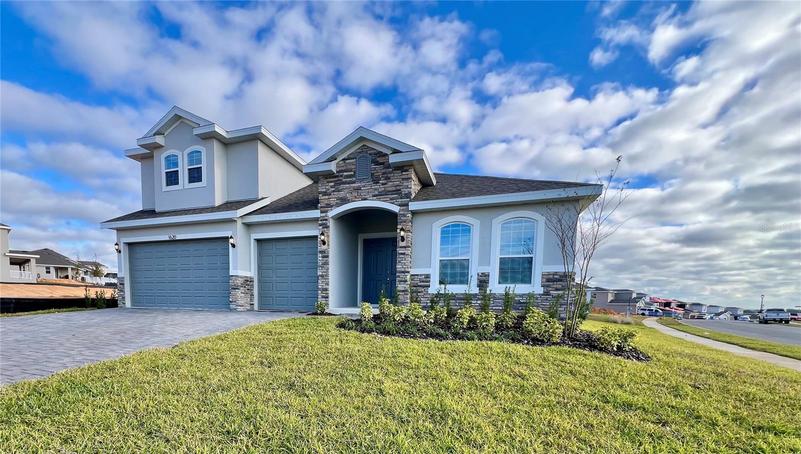 Virtually Staged. Discover the impressive Avalon with Bonus—a spacious and highly upgraded 5-bedroom home offering exceptional living in the Hills of Minneola. This beautifully designed floor plan features a generous bonus/media room, perfect for movie nights, a game room, or an additional family retreat. The highlight of the home is the huge chef’s kitchen, complete with expansive prep space, quartz countertops, premium cabinetry, and upgraded finishes throughout. Stylish laminate flooring flows seamlessly through the main living areas, adding warmth and durability. Situated on a desirable corner lot, this home provides added privacy, natural light, and room to enjoy outdoor living. Thoughtful upgrades are featured in every room, delivering both luxury and functionality. Located within the master-planned Hills of Minneola community with resort-style amenities, convenient Turnpike access, nearby shopping and dining, and the new Minneola Horizon Academy K–8 just minutes away. A true standout home!