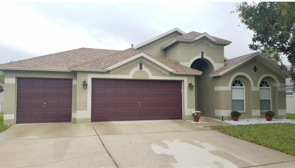 Move in ready 4/2/ with 3 car garages in the gated community Iverson, in Meadow Pointe! Freshly painted interior, 2,095 sq ft home with combo living room/dining room and separate family room. The kitchen features granite counters, upgraded stainless steel appliances including 5 burner gas range with convection oven & microwave. Spacious family room with sliding glass doors leading to the oversized screened in lanai. Master suite off of the family room, master bath has separate vanities, garden tub, separate walk-in-shower, and a large walk-in closet. Carpet free home with newly installed vinyl flooring in all the bedrooms including the formal living room and dining room. The home has a whole house water filtration.. Conveniently located to Wiregrass Mall, Tampa Premium Outlets, shopping, restaurants, with easy access to the interstate