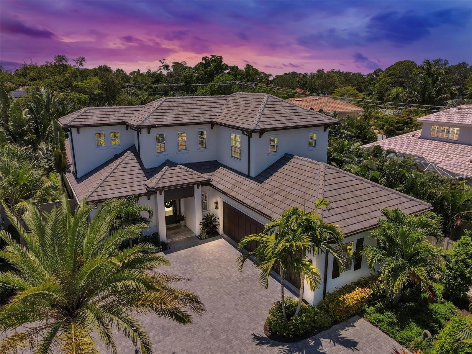 Welcome to West Bay — an exclusive, gated enclave “West of the Trail” offering luxury, privacy, and proximity to everything Sarasota has to provide. Built in 2019 by Heritage Builders, this stunning West Indies–style residence blends timeless design with modern comfort.

Step inside to a fabulous open floor plan featuring 4 bedrooms, 3.5 baths, a den, and a spacious bonus area. The primary suite is conveniently located on the main floor along with a den ( currently being used as a 5th bedroom)  and an additional en suite guest bedroom — ideal for visitors or multigenerational living. Upstairs, two bedrooms share a Jack and Jill bath and a large bonus room perfect for a media, play, or fitness area.

The gourmet kitchen is a showstopper with Shaker cabinetry, quartz countertops, Viking appliances, a walk-in pantry, and a large island with seating — ideal for entertaining or everyday living. Designer touches include wide-plank wood flooring, high coffered ceilings, elegant moldings, custom window treatments, and built-out closets throughout.

Thoughtfully designed with energy efficiency in mind, the home features High-E impact windows and doors, spray foam insulation, insulated garage doors, Big A$$ fans and a tankless water heater.

Situated on the largest lot in West Bay, this home offers a private outdoor oasis with lush landscaping with low voltage uplighting, an inviting pool and spa, outdoor kitchen, automated roll down screens for lanai and expansive pavered patio — the perfect setting for relaxing or entertaining.

Enjoy an unmatched Sarasota lifestyle just minutes to Siesta Key beaches, Southside Village, and Downtown Sarasota, all while tucked away in a serene gated community.