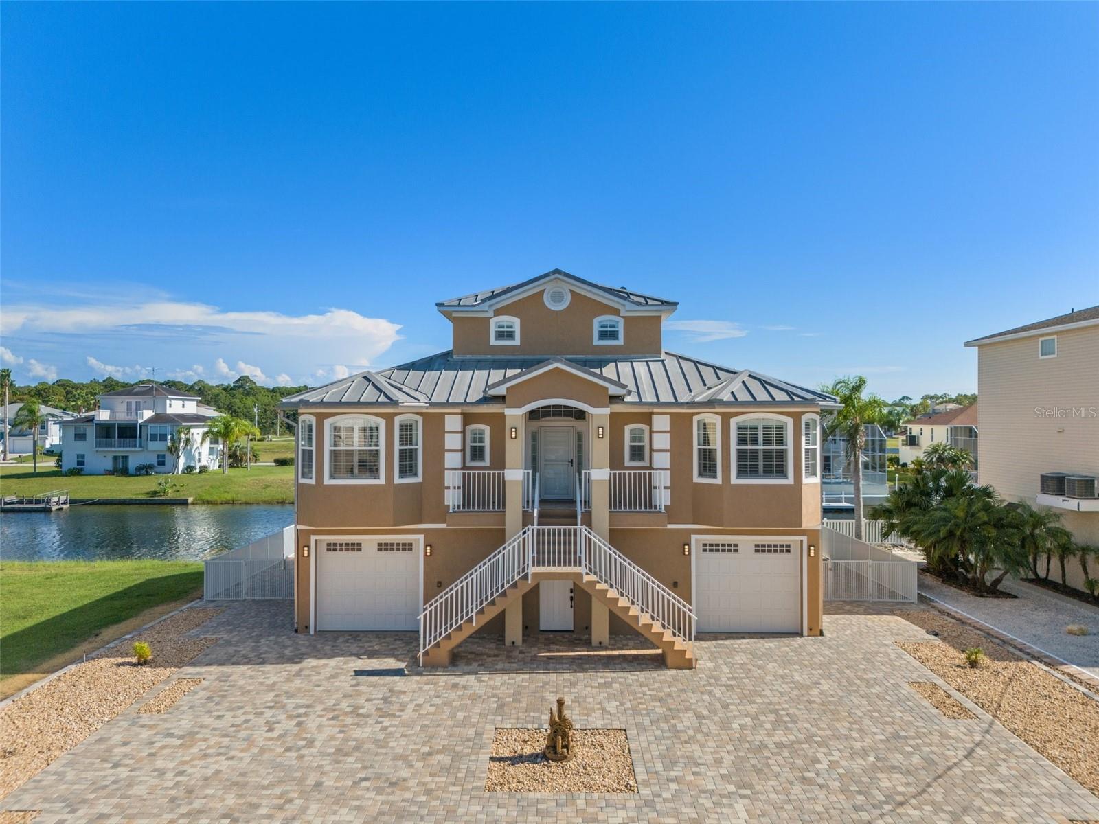 Exceptionally well maintained, fully furnished, remodeled waterfront home with four bedrooms, three full baths, pool, and elevator located in Hernando Beach South. This home features a newly remodeled kitchen with wood cabinets, quartz countertops, stainless steel appliances, cabinet lighting, breakfast bar, and a farmhouse sink; all three bathrooms have also been remodeled with walk-in showers, rain shower heads and new vanities; laminate flooring throughout the house; tongue and groove wood ceiling in the great room and kitchen; plantation shutters on every window; double pane windows; the master bedroom suite on the third floor has a vaulted ceiling and private balcony with gulf views; laundry room with storage cabinets; a screened in lanai located off of the great room; custom ceiling fans and lighting; tankless water heater; security system; and the home is equipped with a whole house generator. Features of the exterior include maintenance free landscaping with brick pavers and stone (no grass to cut); fenced back yard; floating dock; seawall with knee wall and walkway; custom exterior uplighting; 24 x 12 inground pool with waterfall spa; a metal roof; gutters, sprinkler system and an epoxy coated garage floor. HVAC system new in 2025.