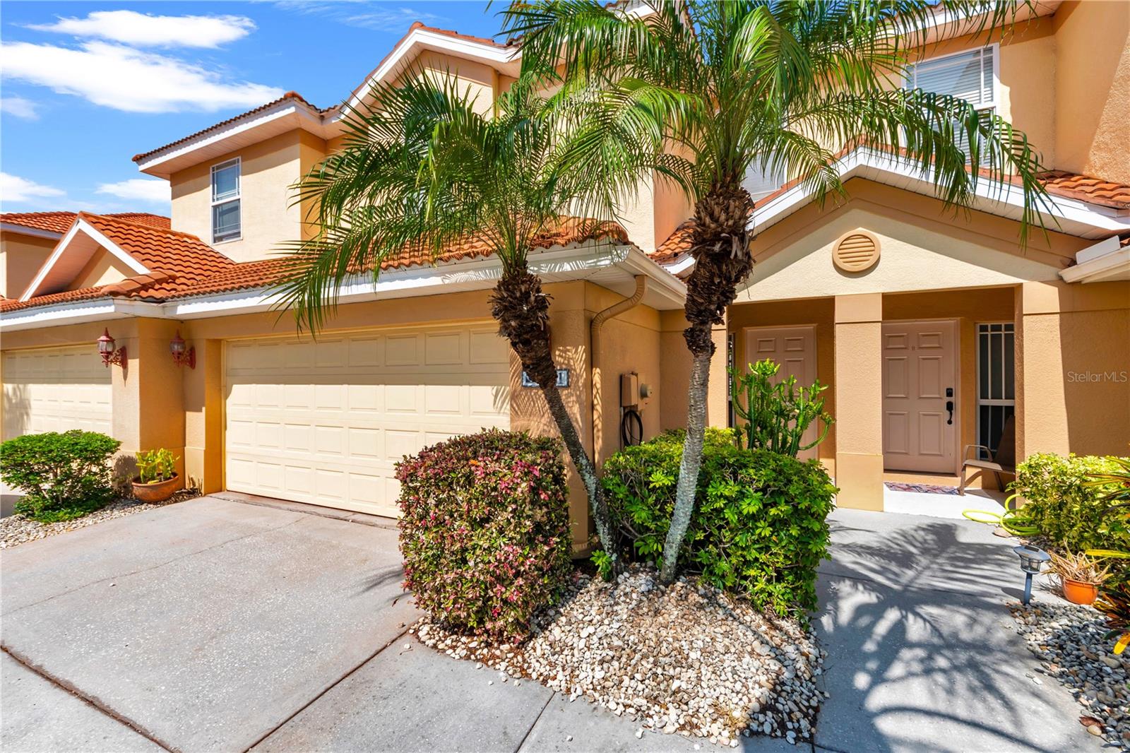 This stunning, move-in-ready, 1,881-square-foot townhome checks off all the boxes. It is spacious, comfortable, and very low maintenance. What more could anyone ask for? Nestled on a quiet cul-de-sac in a highly desirable Tarpon Springs neighborhood, this freshly painted three-bedroom, 2.5-bath home offers a thoughtfully designed, functional layout filled with a welcoming ambiance. Boasting a beautiful barrel tile roof and cooled by a newer central air conditioner (2021), this property perfectly blends style and easy living. A modest $350 monthly HOA fee provides incredible value, covering the roof, entire exterior maintenance, landscaping, sprinklers, cable TV, and high-speed internet. The exterior features a private two-car garage, a personal driveway, a mailbox, and an inviting private entry. Step inside to a bright, open floor plan optimized for effortless entertaining and daily living. The main level is adorned with high ceilings, elegant crown molding, and beautiful porcelain tile flooring throughout. A chef’s dream, the gourmet kitchen showcases premium 42-inch wood cabinetry, granite countertops, stainless steel appliances, and a breakfast bar that seamlessly connects to the expansive great room. Just off the kitchen and living areas, you will find a convenient powder room and a separate storage closet tucked beneath the stairs. Tall sliding glass doors, outfitted with plantation-style sliding door window treatments for ultimate privacy, open to a peaceful, screened porch overlooking a tranquil creek—the perfect spot for morning coffee or evening relaxation. Upstairs, the home features high ceilings and comfortable carpeting throughout. The luxurious primary suite serves as a private sanctuary, complete with an elegant tray ceiling, a spacious walk-in closet, and a spa-like en-suite bath featuring a soaking tub, a separate walk-in shower, and dual sinks mounted into a beautiful marble-look Corian countertop. Separated from the primary suite for maximum privacy is a versatile bonus room or loft area, which leads to two generously sized guest bedrooms—each boasting its own private walk-in closet. A second full bathroom and a conveniently located laundry room complete the upper level. Location is everything, and this home is perfectly situated just blocks from the World famous Innisbrook resort, Tarpon Springs Public Golf Course, the scenic Pinellas Trail, and AdventHealth North Pinellas Hospital. You are just minutes away from award-winning dining and entertainment at the world-famous Sponge Docks and the historic downtown district, both of which host vibrant festivals and local events throughout the year. Soak up the sun at your choice of two local public beaches—Sunset Beach and Fred Howard Park—both located just minutes from your front door. With quick access around the corner to US Highway 19, you can easily explore everything the Tampa Bay area has to offer, including Palm Harbor, Dunedin, Clearwater beach, and two major airports—Tampa International and St. Pete-Clearwater International—both under a one-hour drive away. Don't miss your chance to own this move-in-ready gem. Schedule your private showing today!