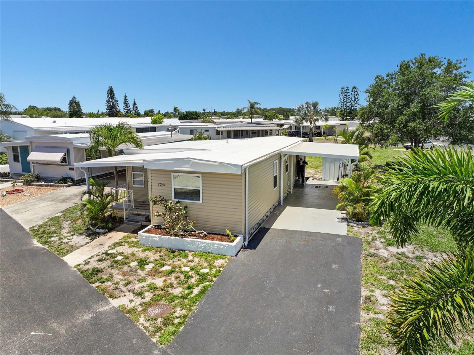 Where will you find a totally remodeled 2 bed/1 large bath home with so many upgrades that it shows like a NEW home at this low low price? Located in the popular 55+ factory-built housing community of Americana Cove, this stunning home must be seen to be believed. The 2026 upgrades are many: 1) Open floorplan with split bedroom plan for guest and owner privacy. 2) All new kitchen with stainless appliances, garbage disposal, wood cabinets with soft close drawers, recessed lighting, and quartz countertops. 3) Beautiful luxury waterproof vinyl flooring throughout with new baseboards. 4) New drywall on ceiling and walls painted in neutral decorator colors. 5) New washer and dryer in utility closet for ease of use. 6) Beautiful bath with walk-in tiled shower, new vanity and comfort height toilet. Not only has the interior been improved, the major systems of the home were replaced and include new double paned windows, all new plumbing, new mini splits for efficient heating and air, new vapor barrier to protect the subflooring, new carport, new vinyl siding and new doors. The roof is 2020. No flooding in 2024 storms! The home appears larger since the 200 sq ft porch has been combined into the living area making for a spacious living and dining retreat. Price includes share for the lot and ownership in the co-op. Low monthly maintenance fee of $410 includes 24 hr manned gate, clubhouse, pool, fitness center, 2 private boat ramps and kayak launch and so much more! Located only 10 mins to downtown St. Petersburg and 20 mins to downtown Tampa, the access to airports, I-275 and beaches is one of the reasons this community is so popular! 4th St dining, grocery and shopping is minutes away. Downsizing has never been easier! Don’t miss this retirement dream home!
