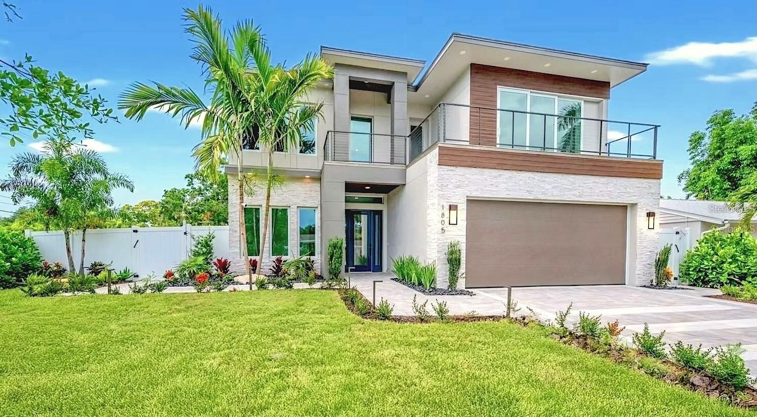 Nestled West of the Trail and just steps from Southside Village, this stunning New Construction 2-story luxury home offers the perfect blend of location, design, and lifestyle. Positioned between Siesta Key’s world-famous beaches and Downtown Sarasota, you'll enjoy easy access to the city’s best dining, shopping, and cultural attractions—all within minutes.

Designed with modern elegance, the home features 5 bedrooms, 5 full bathrooms, and 3,595 square feet of thoughtfully crafted living space. Additionally, there is a large bonus room for an office or gym, an upstairs second living room area, and several balconies to enjoy. From the grand 20-foot ceilings in the main living area to the floor-to-ceiling windows that flood the interior with natural light, every detail has been curated for style and comfort. Light-tone engineered hardwood floors flow throughout the home, with a herringbone pattern in the foyer. The gourmet kitchen is outfitted with GE Cafe appliances, quartz countertops, and custom cabinetry, flowing seamlessly into the open living and dining areas, with a wine display.

Step through glass sliding doors to discover a resort-style outdoor oasis, complete with a covered patio, outdoor kitchen, pool, and hot tub spa, all surrounded by lush landscaping. The first-floor primary suite offers a tranquil retreat with direct outdoor access, a spa-like bathroom, and a generous walk-in closet. Upstairs, three additional en-suite bedrooms and two rooftop decks provide privacy and space for guests or family.

This newly built residence offers peace of mind with the latest in building codes, energy efficiency, and storm protection. Modern insulation, impact-rated windows and doors, and up-to-date mechanical systems translate into lower utility bills, reduced maintenance, and enhanced safety. You’ll also benefit from turnkey readiness—no need for costly renovations or updates.

With its prime location, high-end finishes, and indoor-outdoor flow, this home captures the essence of luxury Sarasota living. Rarely do homes become available in this coveted neighborhood—this is your opportunity to own this exceptional property.
